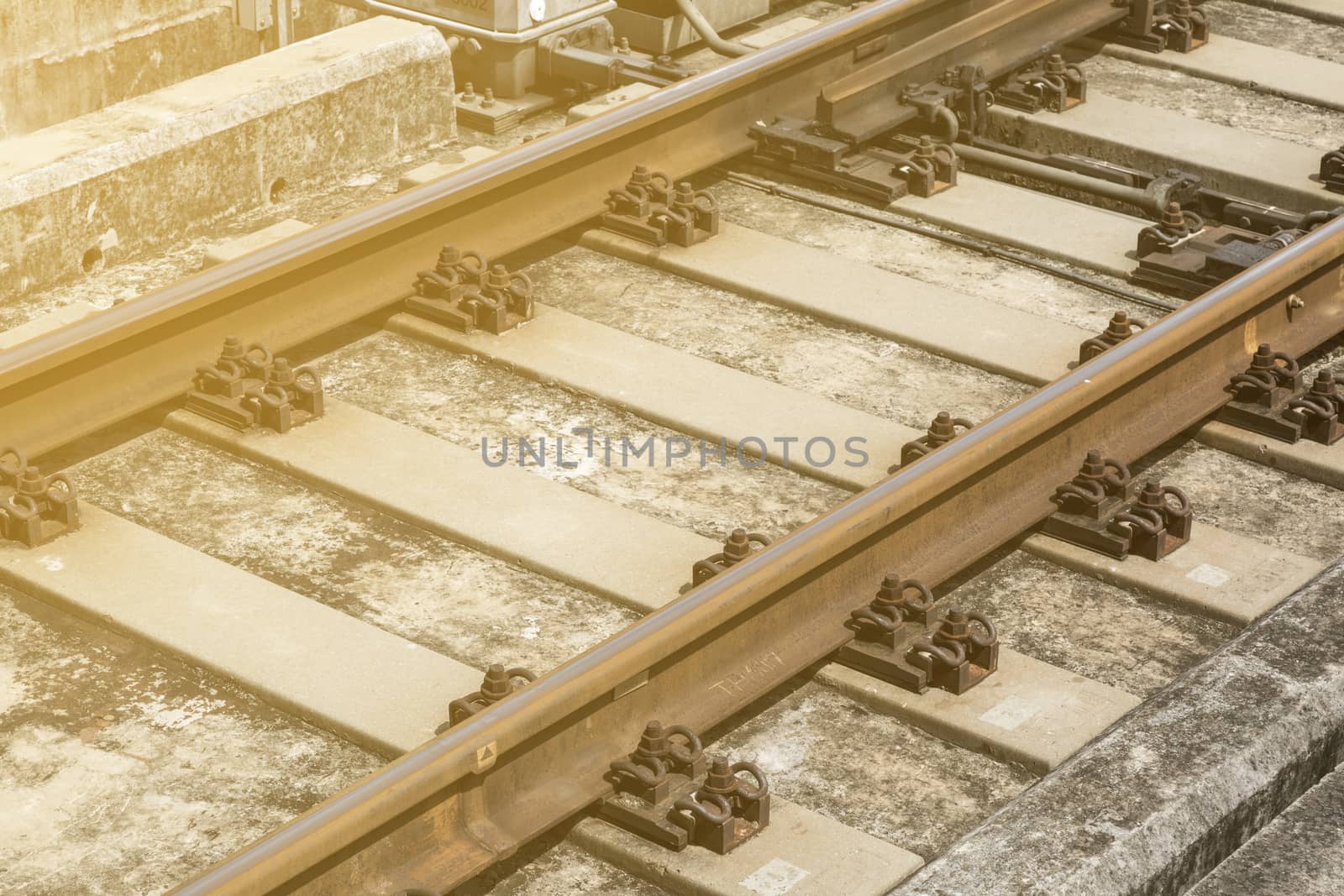 closeuo detail of old rusty railway made form metal  and concreat with lighting 