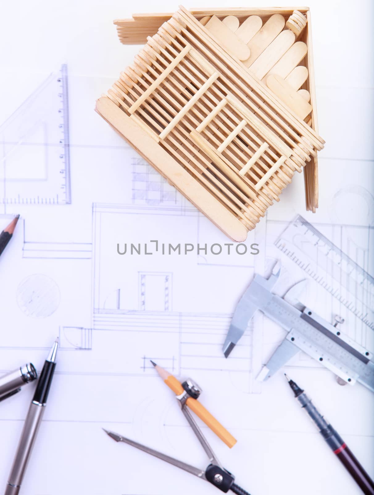architect working table with plan home model and writing instrument and paper work