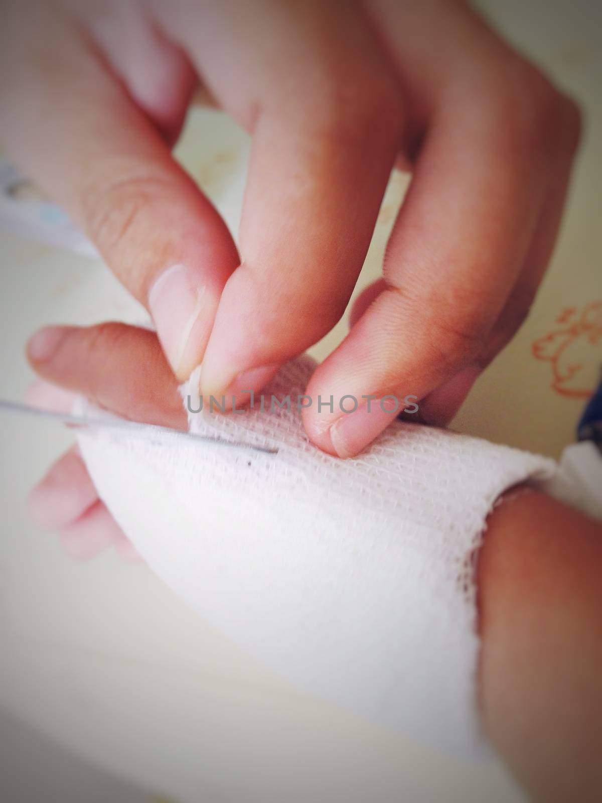 Nurse cut gauze for removing saline needle (selective focus and blur)