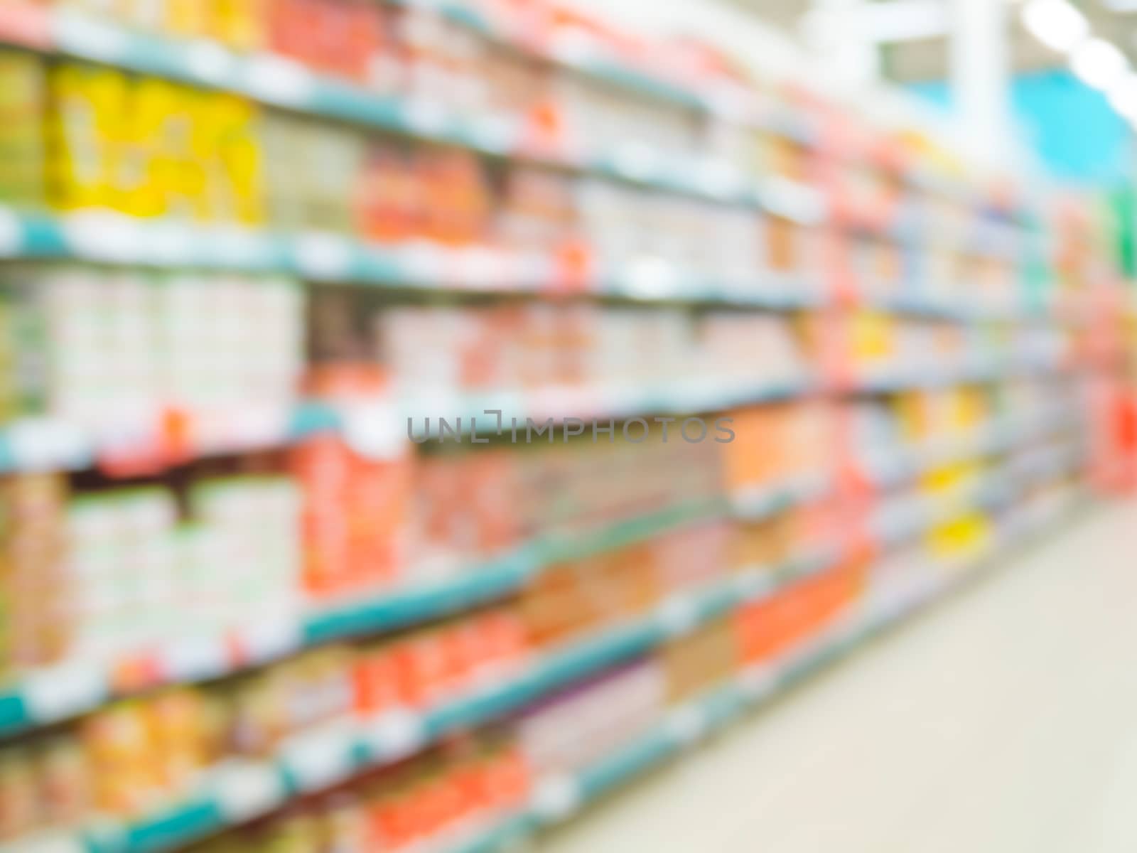 Blurred colorful supermarket products on shelves by fascinadora