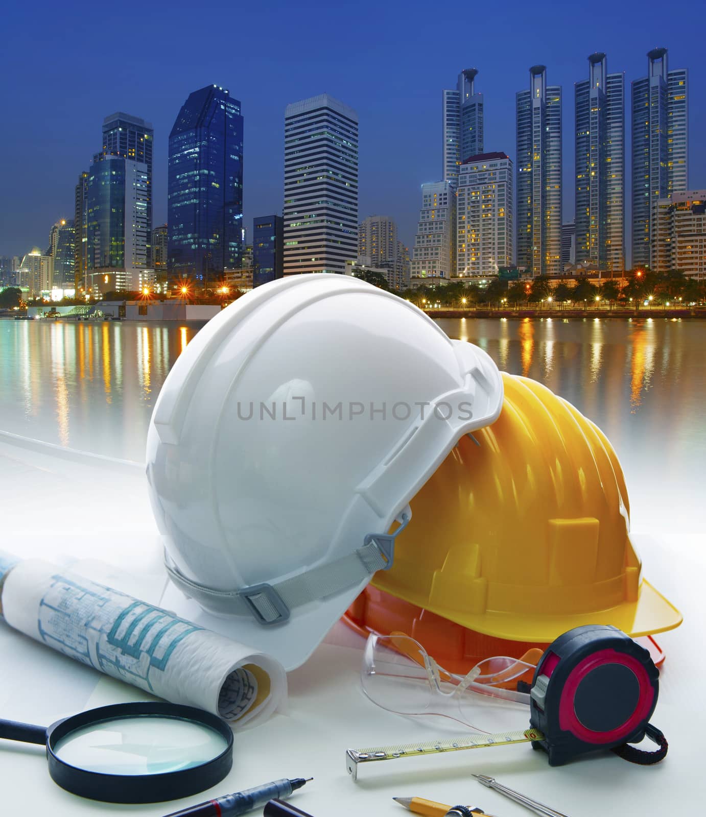 engineer working table with safety helmet and writing equipment  by khunaspix
