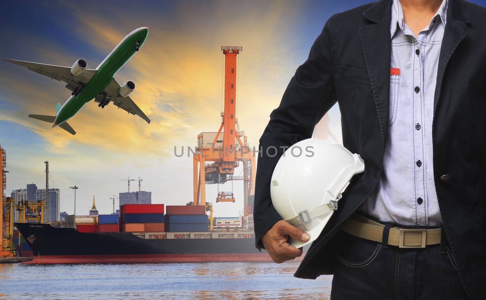 manager man holding safety helmet standing against ship and container on shipping port and cargo plane flying above use for freight and logistic transport industry