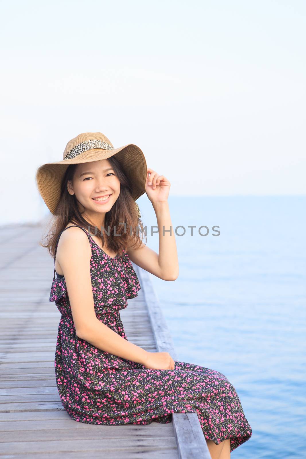 portrait of beautiful woman wearing long dress and straw hat looking to camera use for people vacation in paradise destination