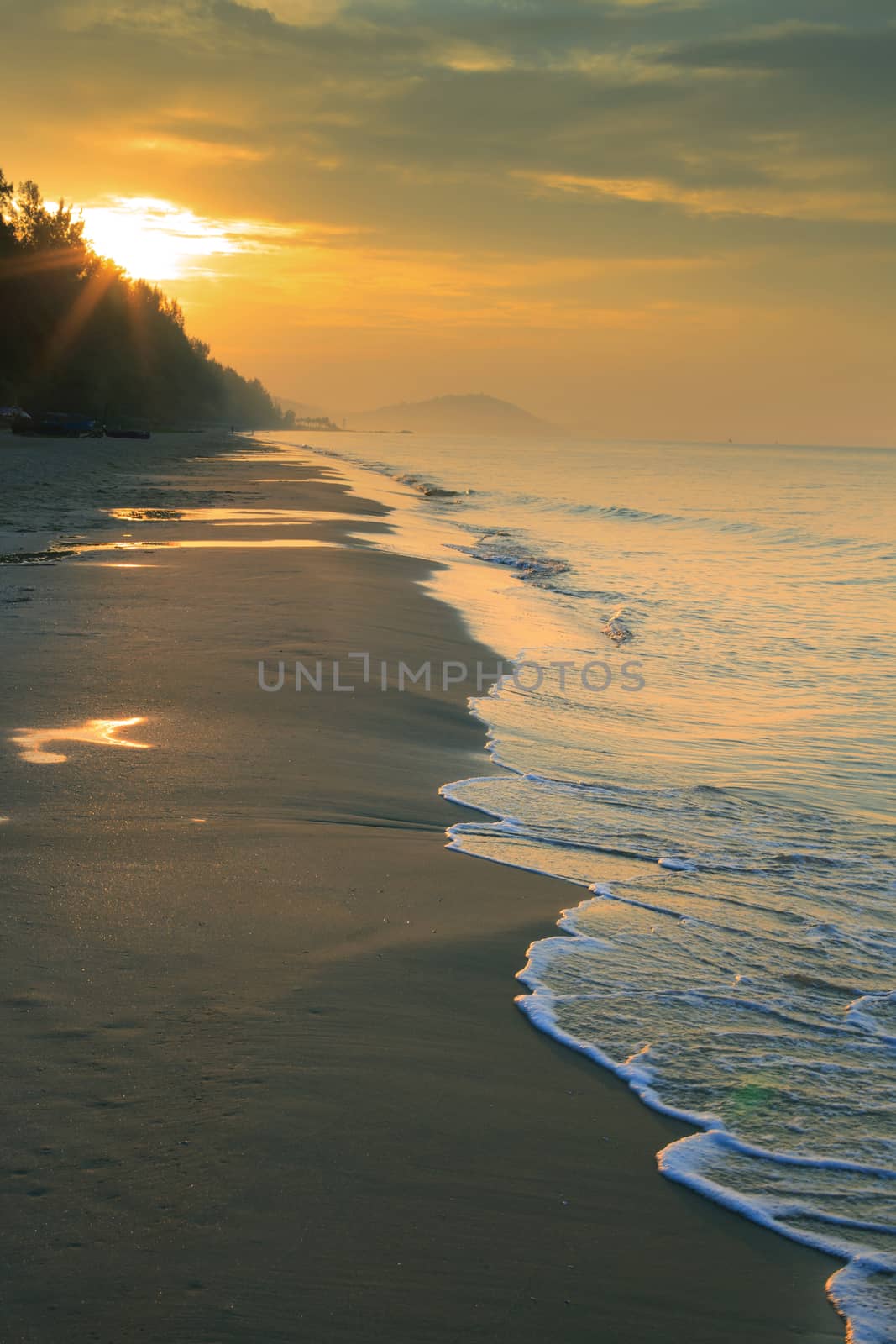 natural land scape of sun rising on sea beach vertical form by khunaspix