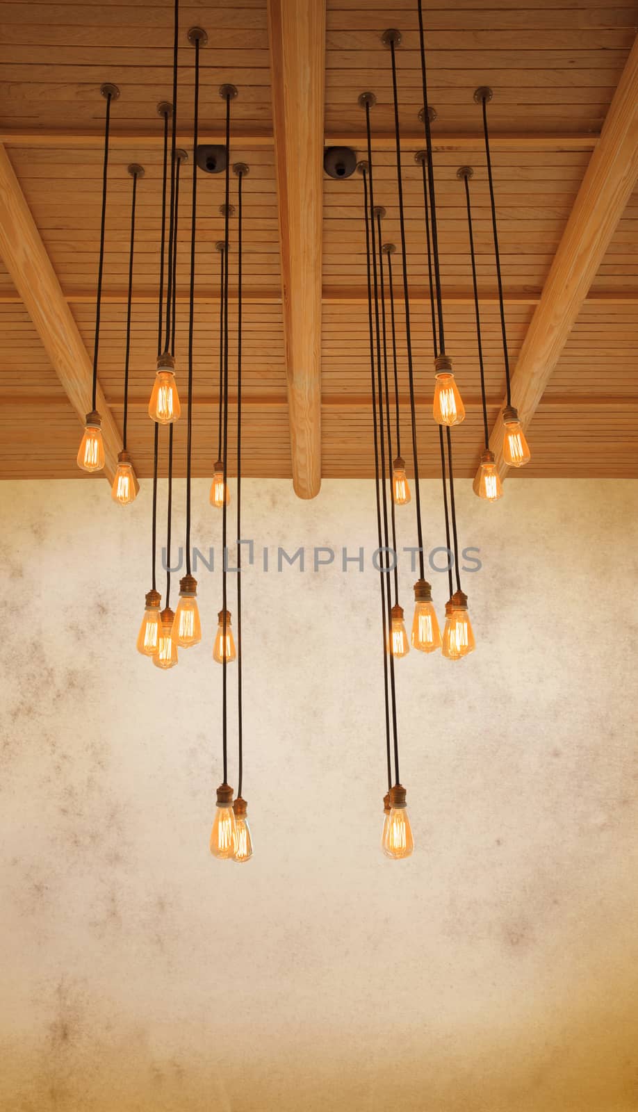 ceiling light bulb hanging on pine wood against warm tone of gru by khunaspix