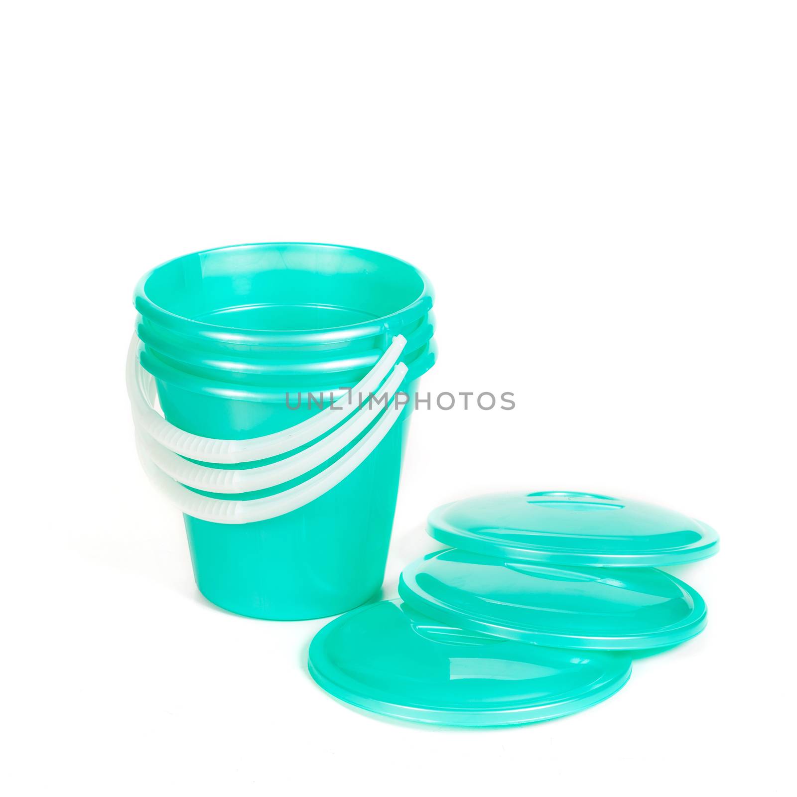 green plastic buckets in a pile with covers  by sveter