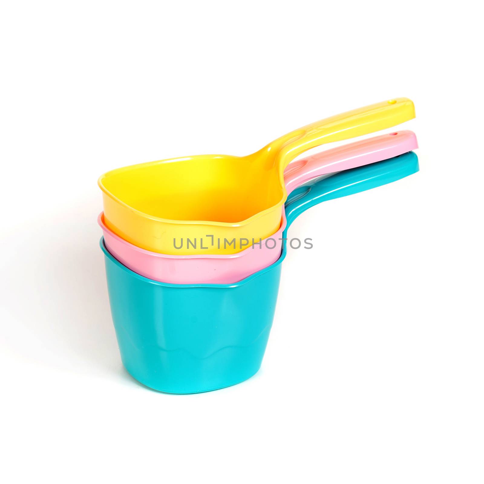 multi-colored plastic ladles on the white isolated background