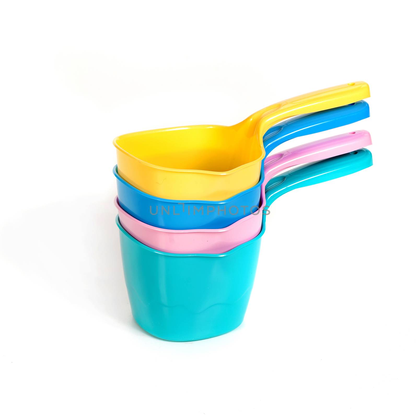 multi-colored plastic ladles on the white isolated background