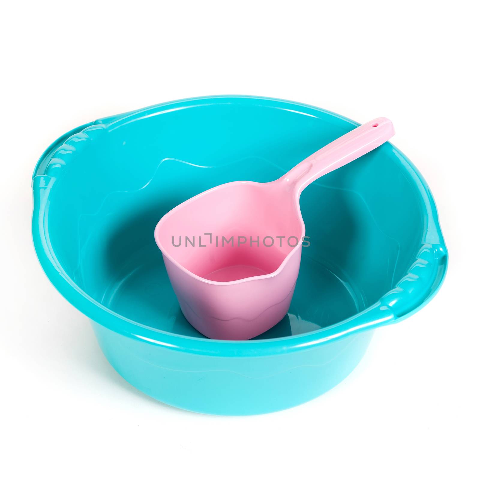 plastic ladle in a basin on the isolated white background