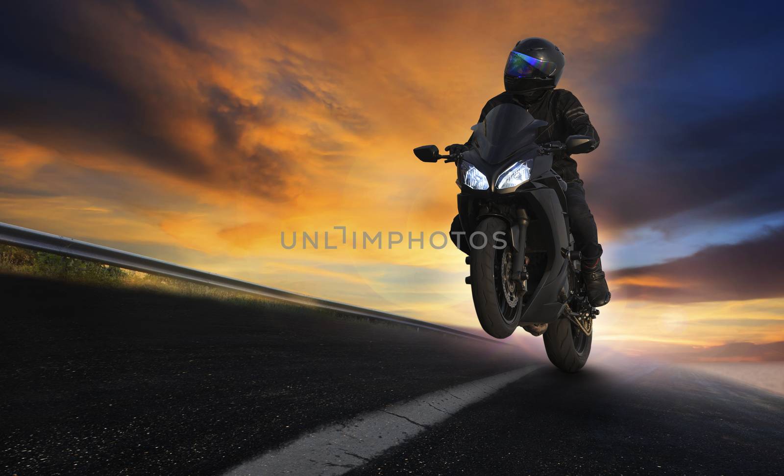 young man riding motorcycle on asphalt highways road with profes by khunaspix