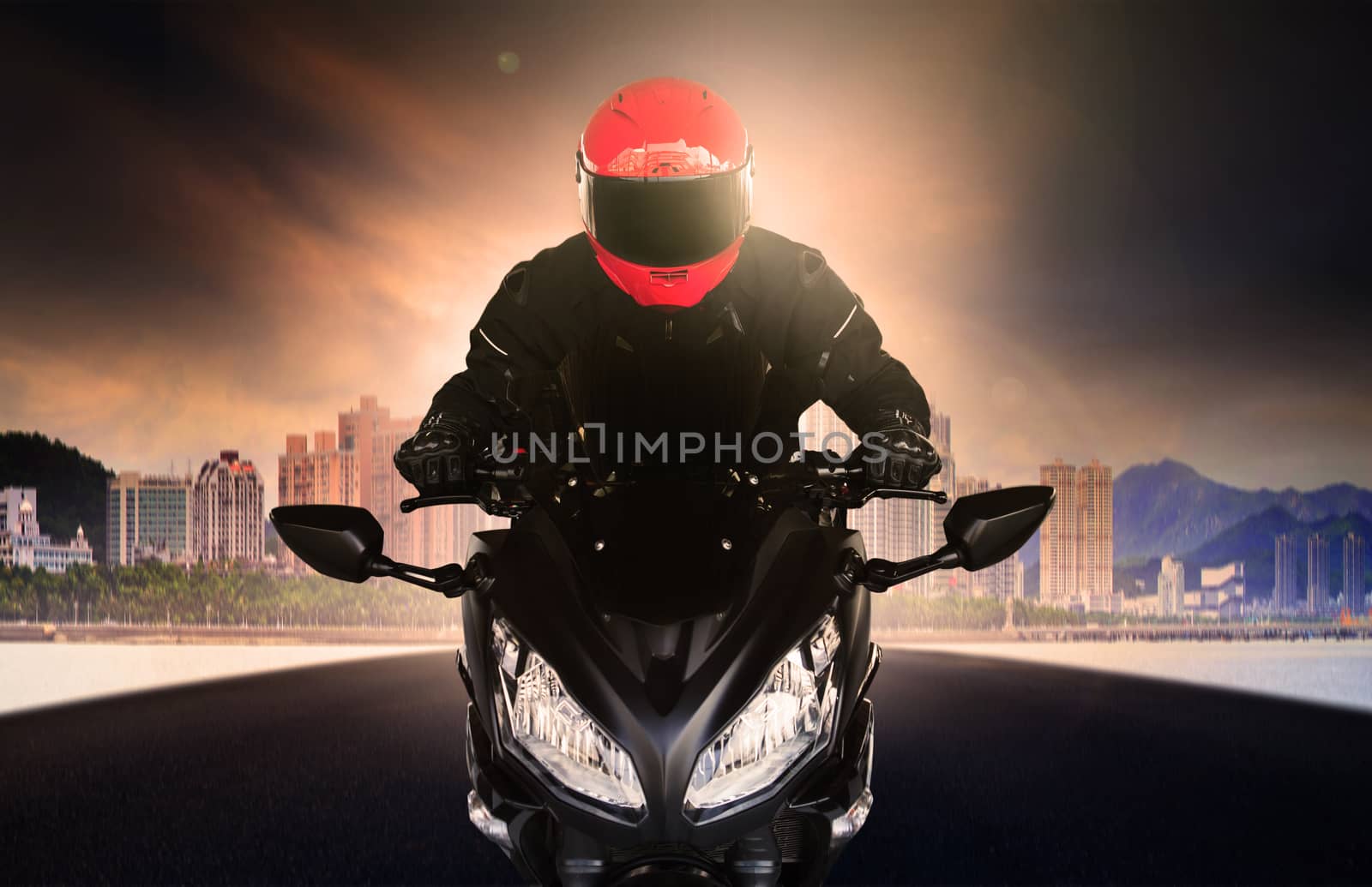 close up rider man wearing safety suit and anti knock helmet riding big bike motorcycle on asphalt street against urban and sky scrapper building use for people activities and city life transportation theme