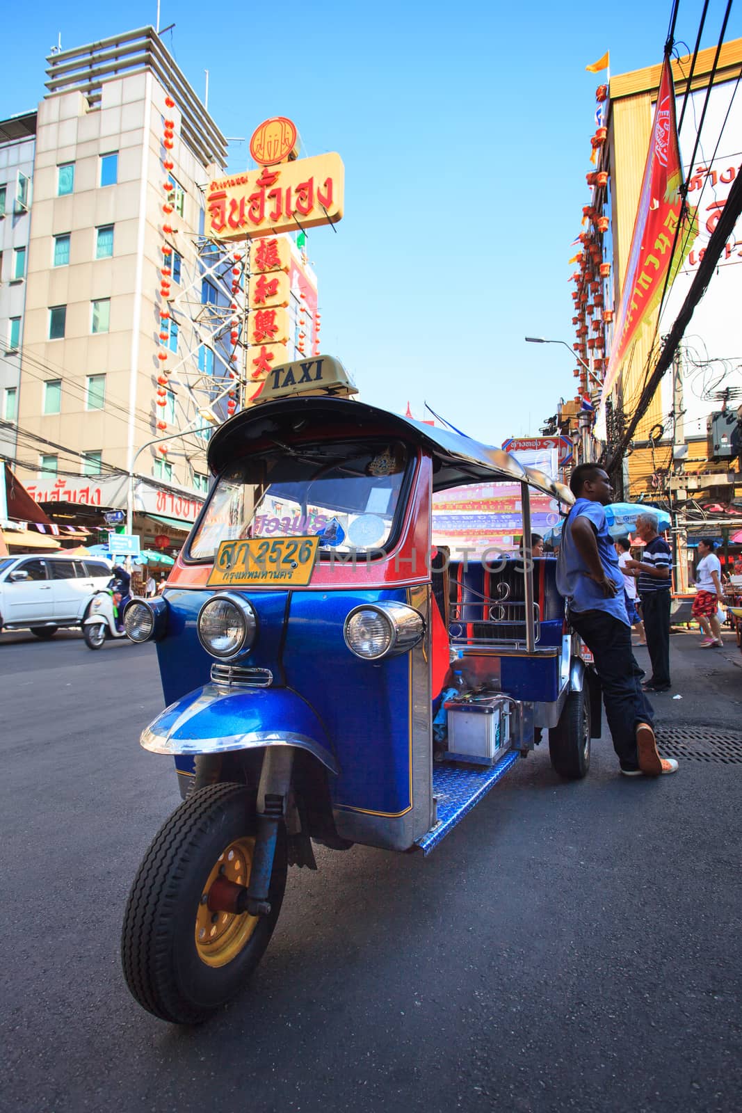 THAILAND,BANGKOK - FEB 24 :Tuk Tuk thailand vehicle symbol parking in Yaowarat Road,the main street in Chinatown, once of Bangkok landmark and important street for sale and buy gold in bangkok on february 24, 2015 in China town, Bangkok Thailand