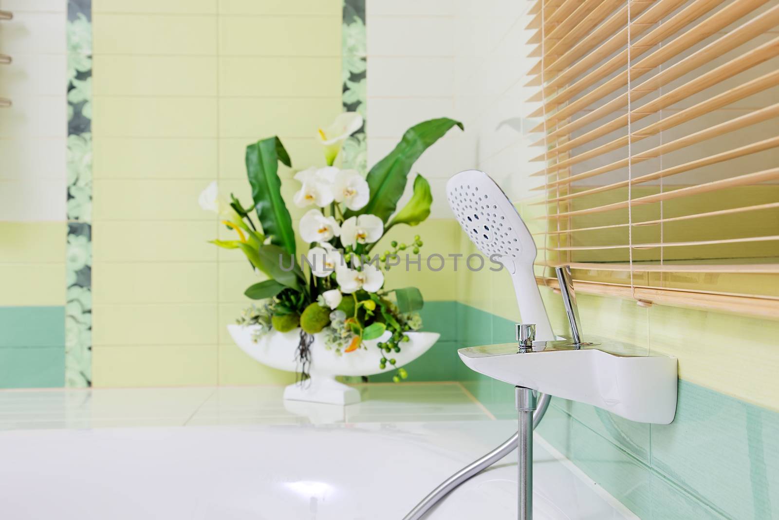 Beautiful white faucet on bathtube   by RawGroup