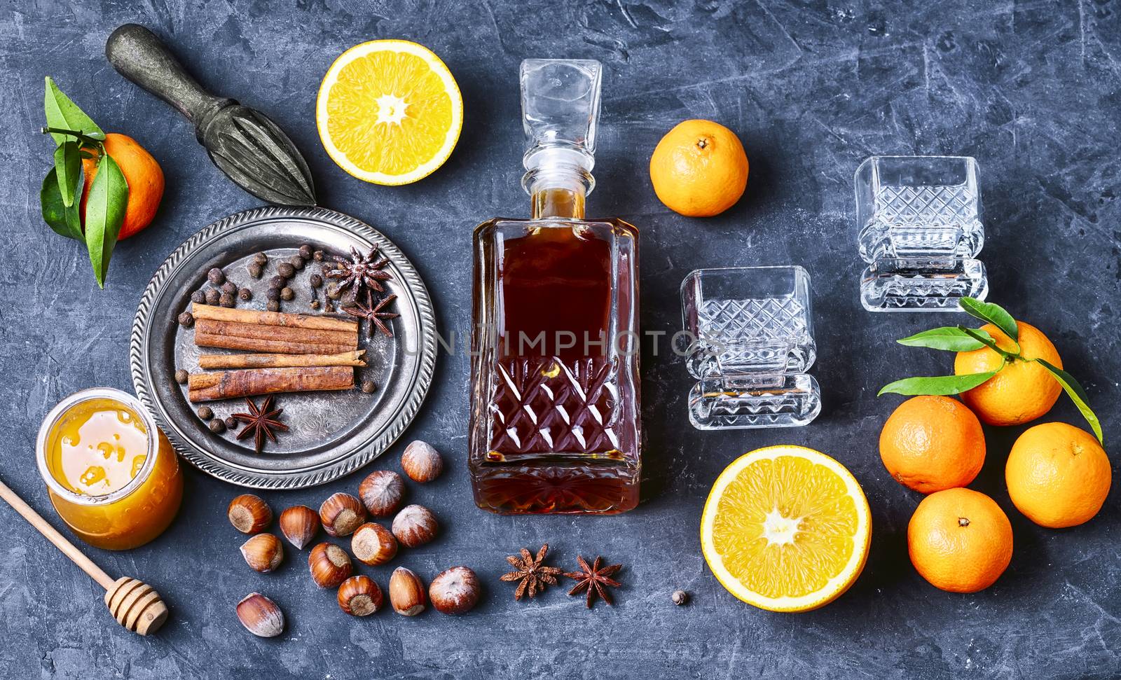 Hot wine with orange and spices set on a dark slate background