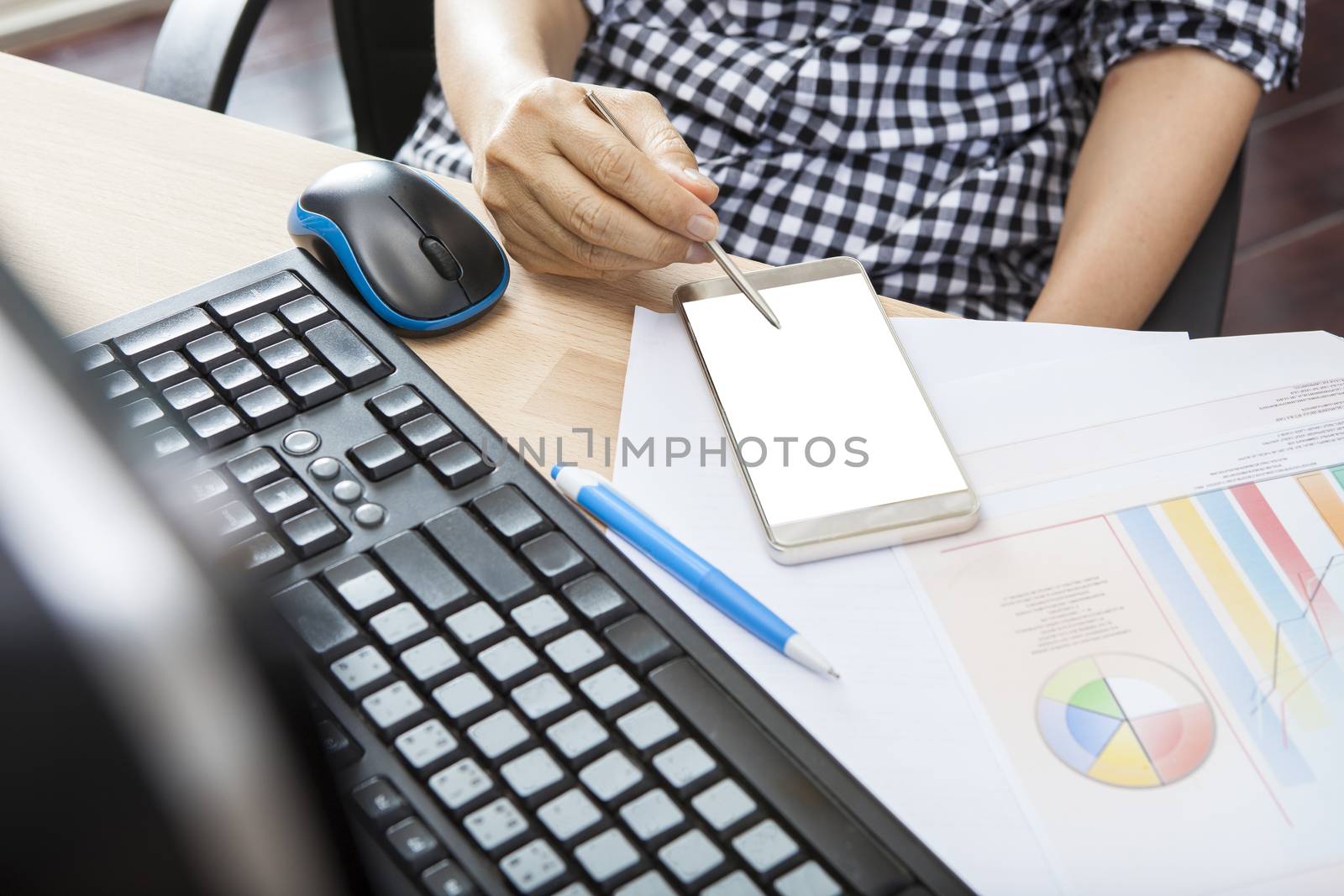 hand of working woman with smart phone writing pen on touching screen with copy space on office working table