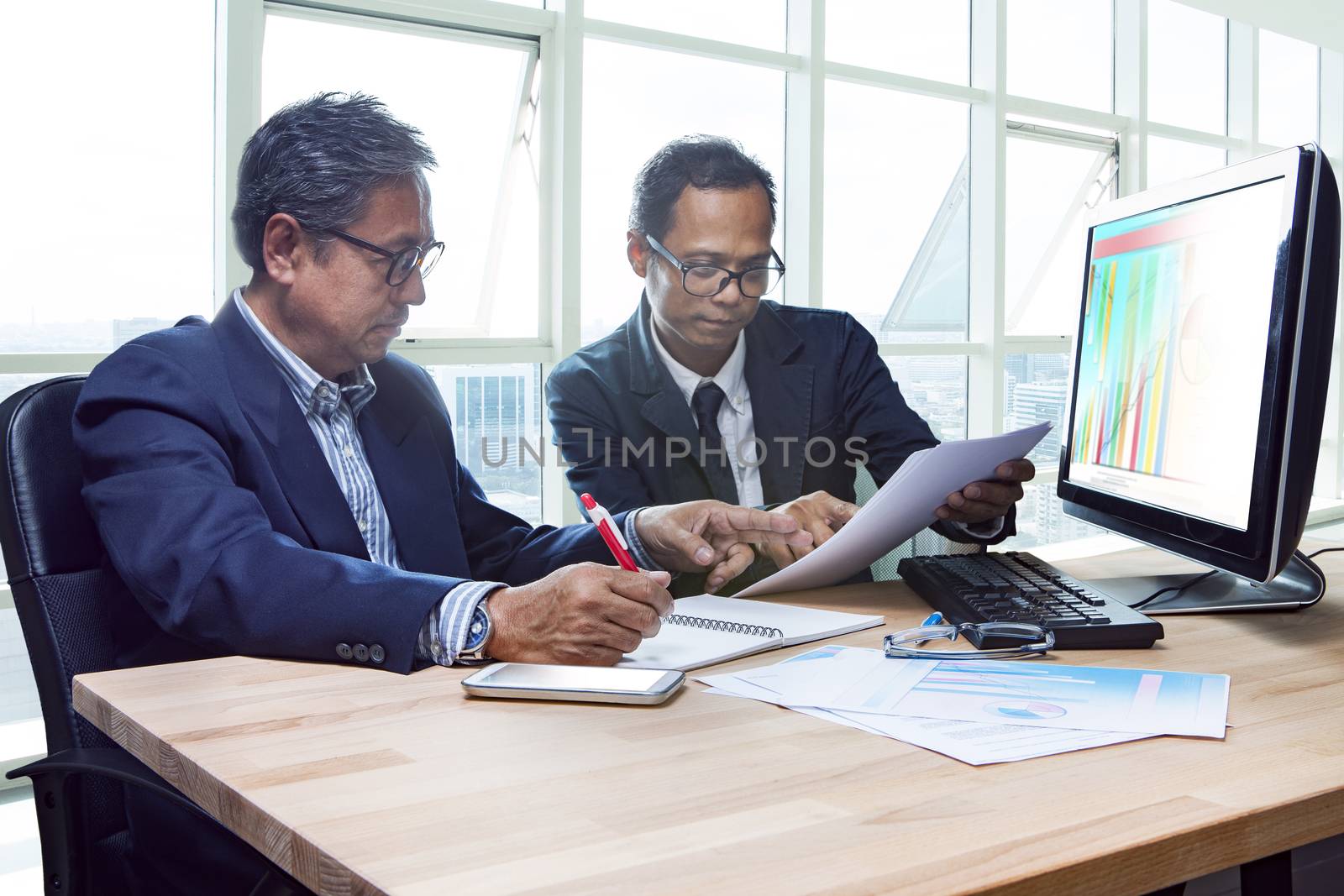 partner of senior engineering working man serious meeting about project discussing solution shot on table in office meeting room 