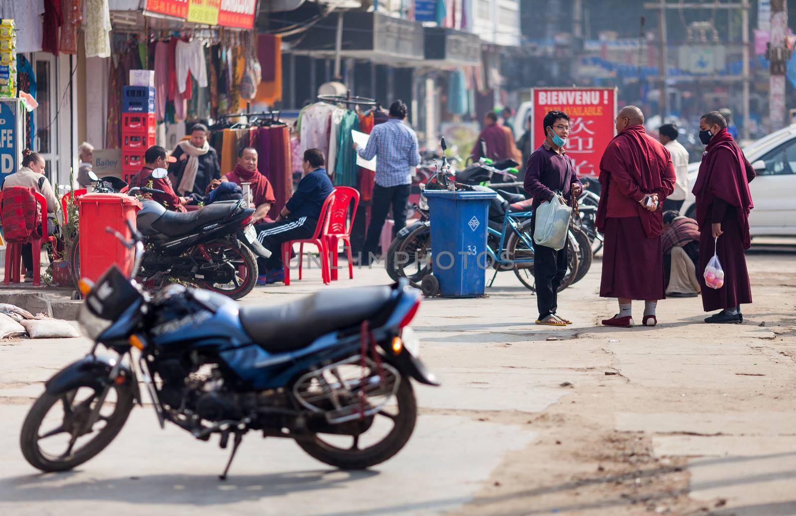 Buddhist monks talk to the pilgrim in medical mask. by dymov