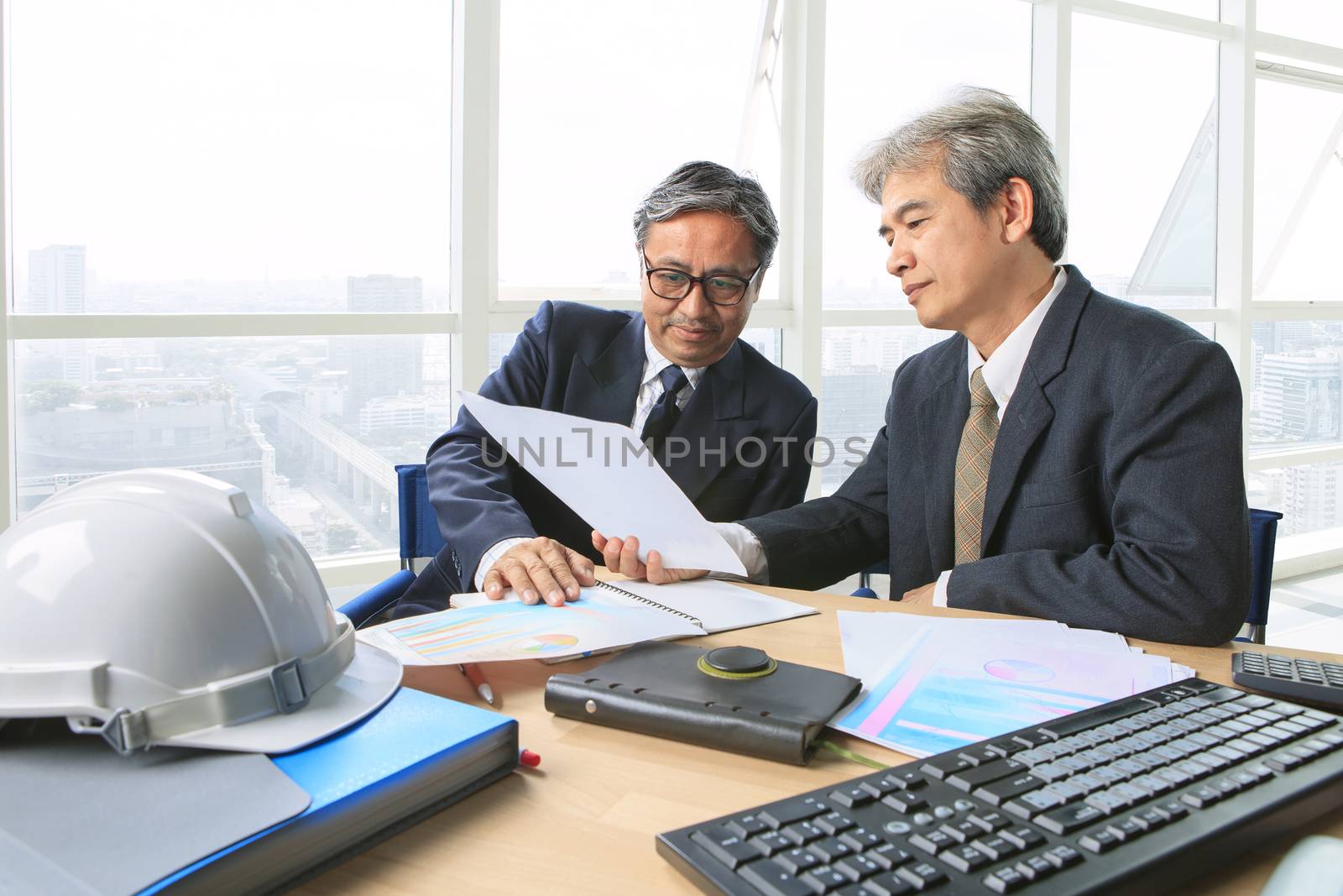 partner of senior engineering working man serious meeting about project dicussing solution shot on table in office meeting room 