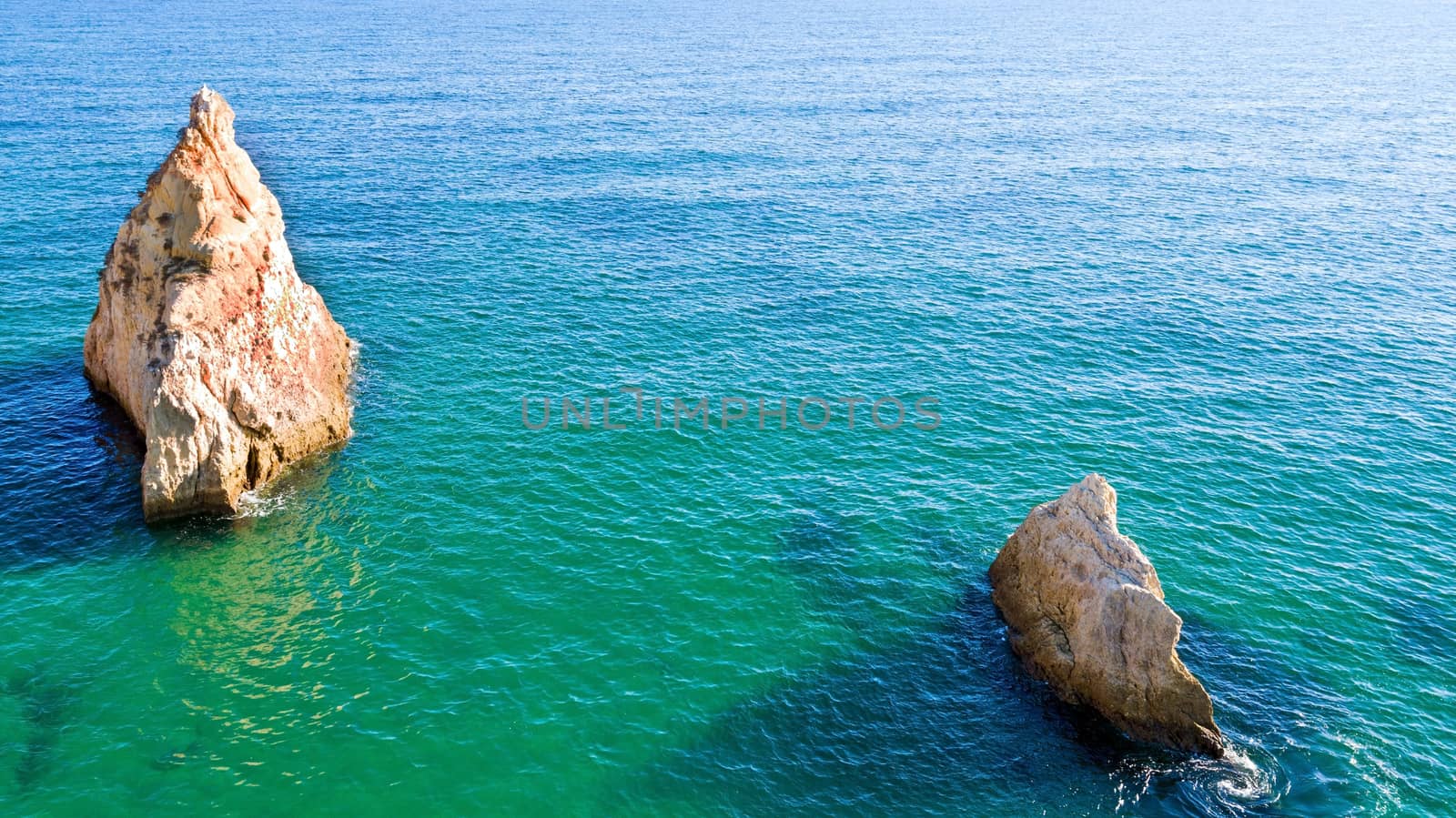 Aerial from natural rocks near Alvor in the atlantic ocean in Portugal