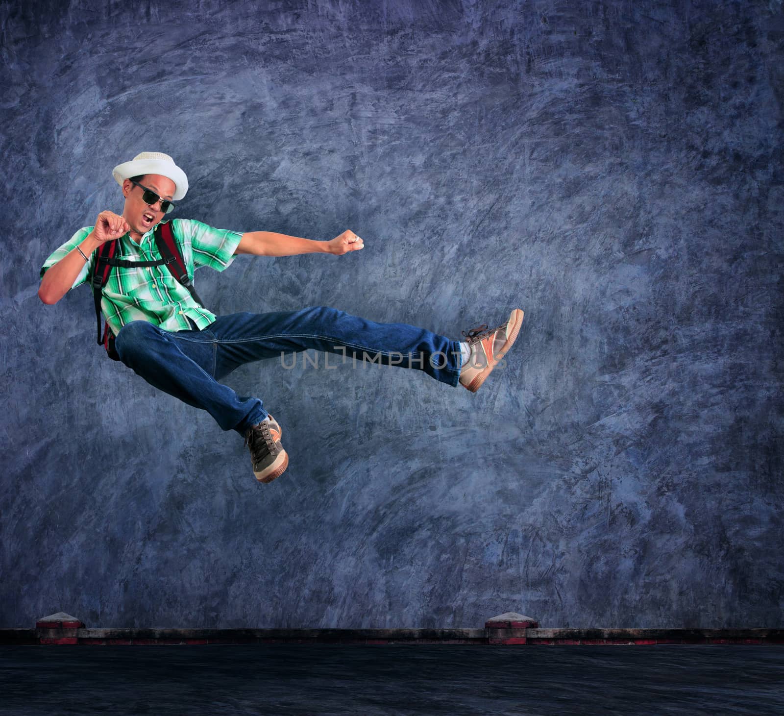 traveling man jumping mid air with exciting emotion against ceme by khunaspix