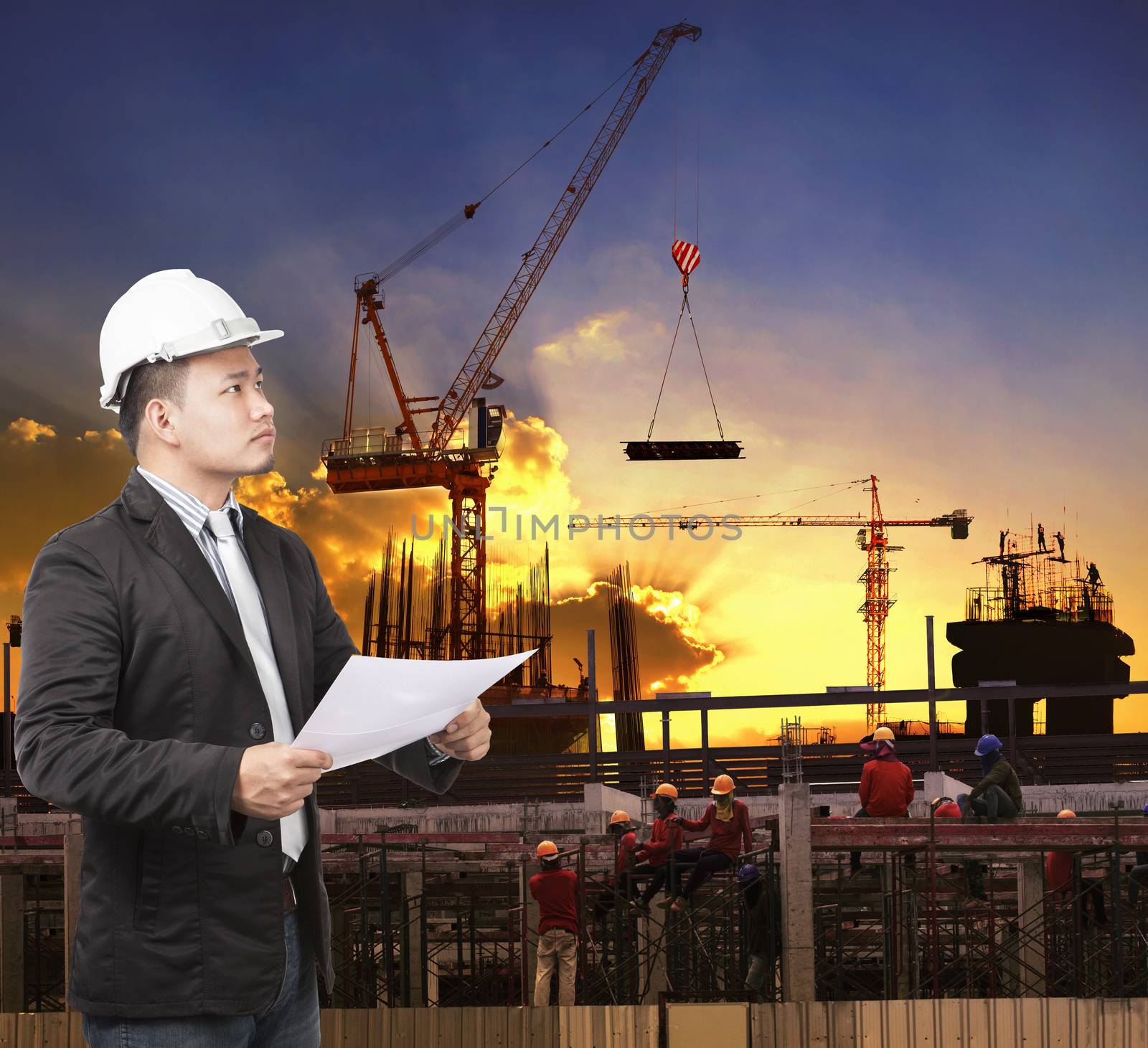 young engineer man working with construction plan in building structure site use for construction business 