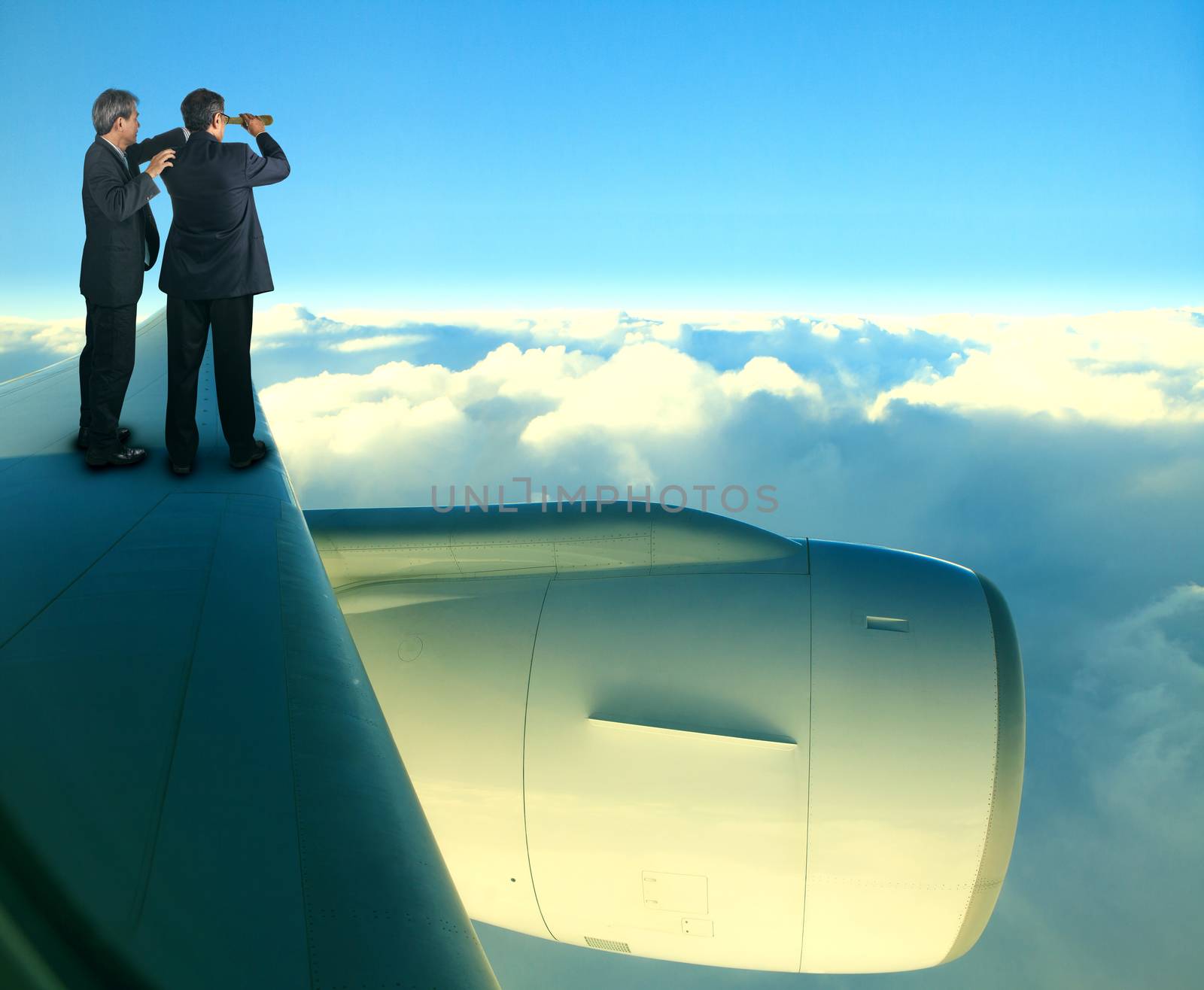 two of asian business man standing on jet plane wing over white  by khunaspix