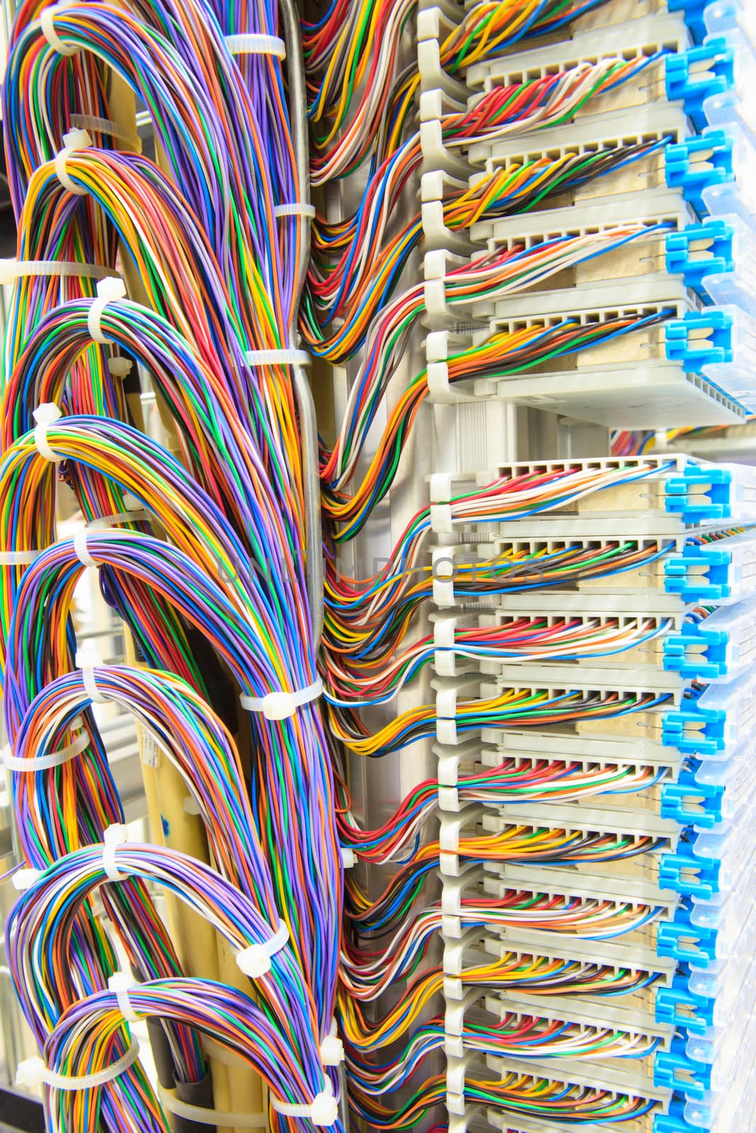 stack of colorful electronic wire in socket board of ditigal telecommunication contral room