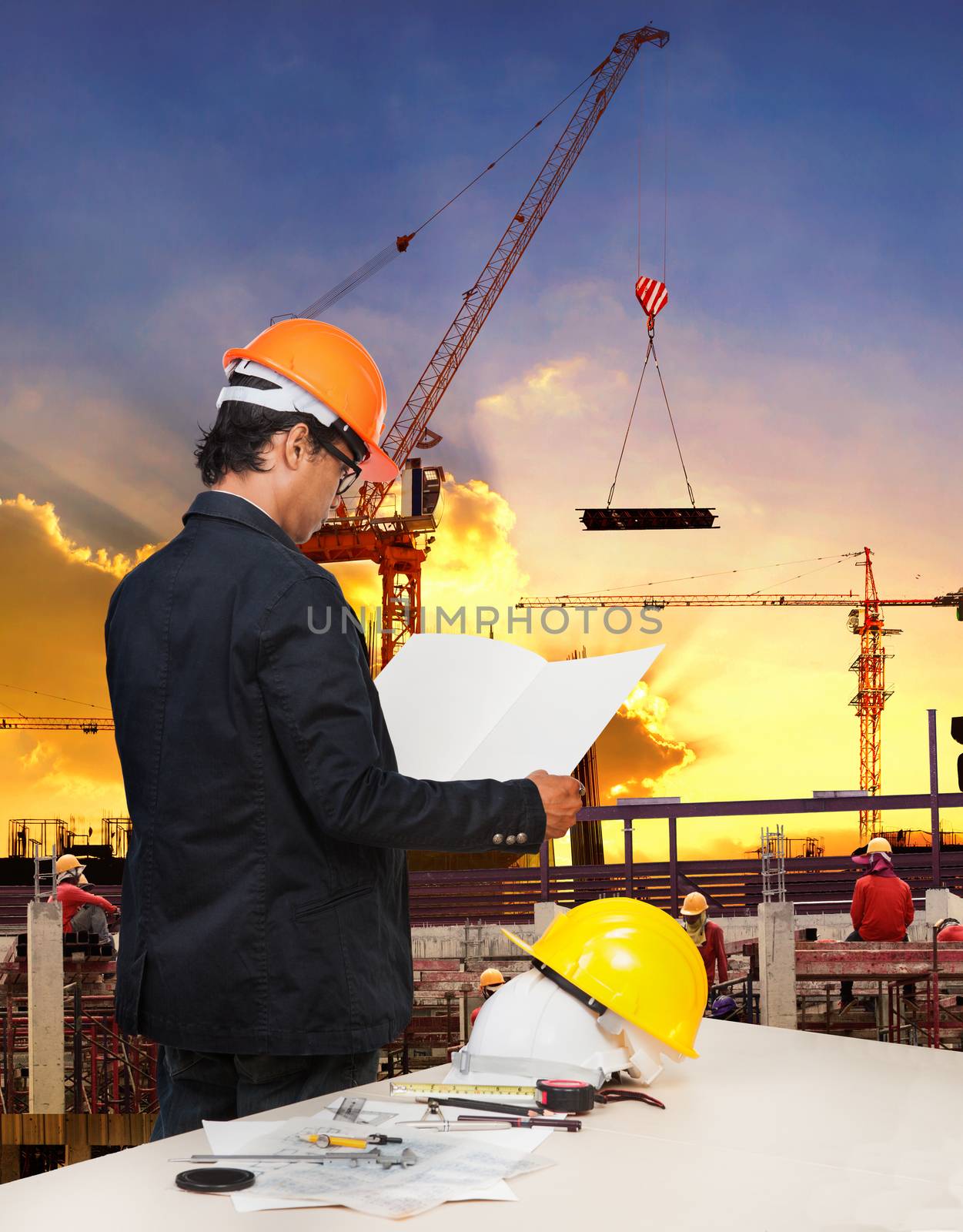 engineering man working in building construction site against be by khunaspix