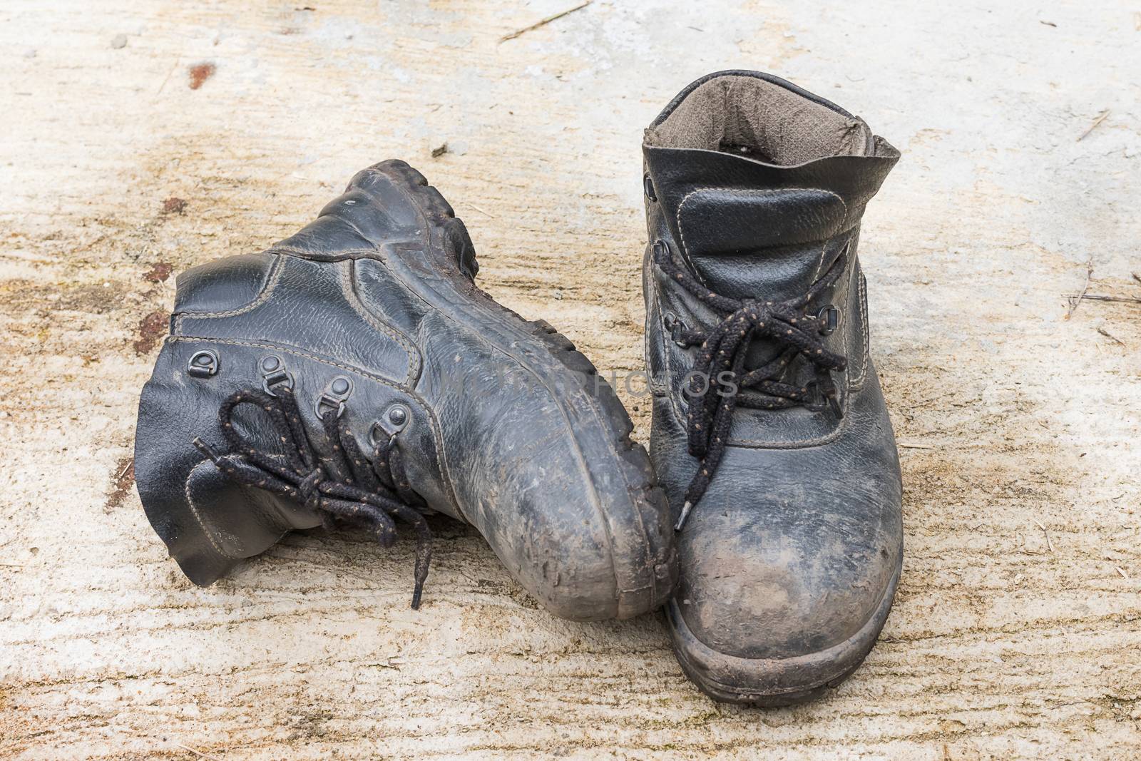 Safety leather man shoe on the cement floor texture background