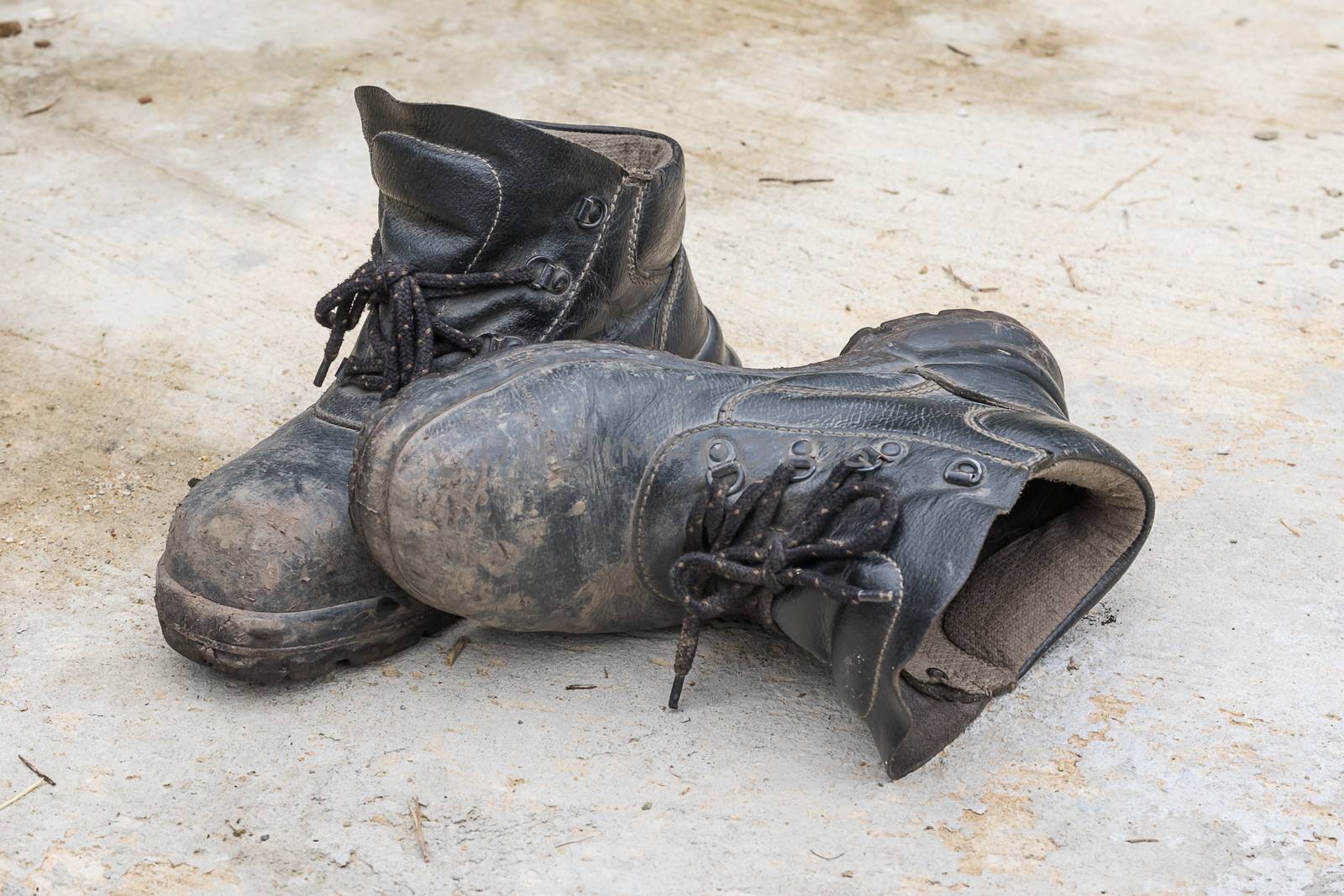 Safety leather man shoe on the cement floor texture background