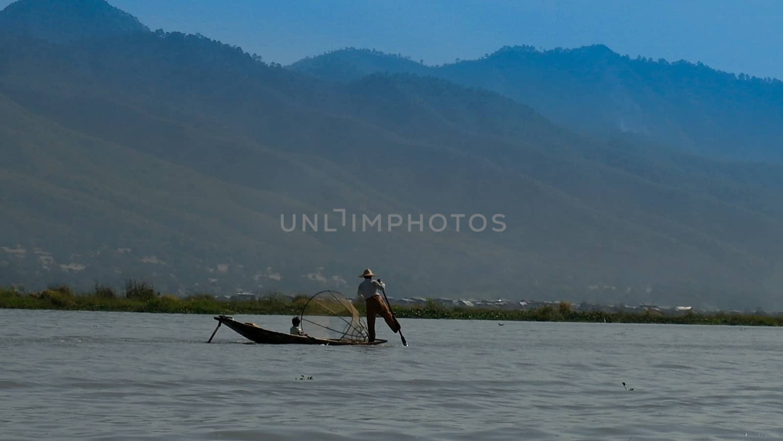 Fisherman on the boat at the sunrise, Inle lake, Myanmar
