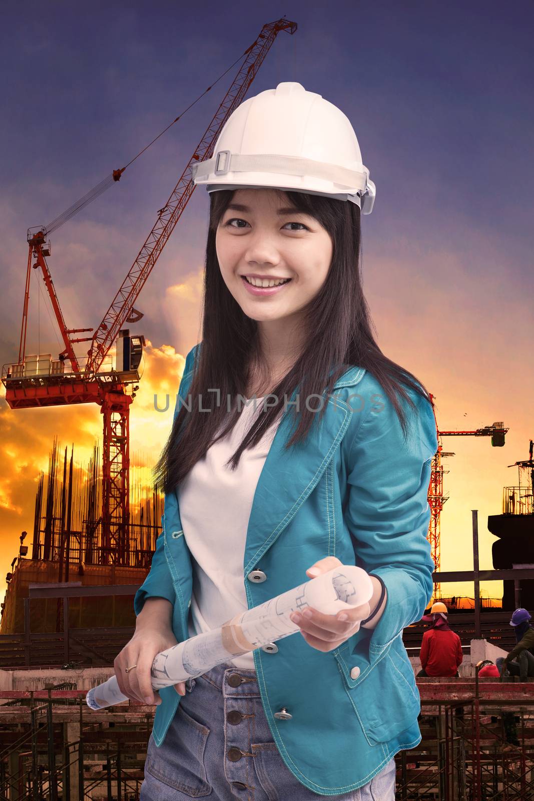 female engineer with construction plant against building stuctur by khunaspix
