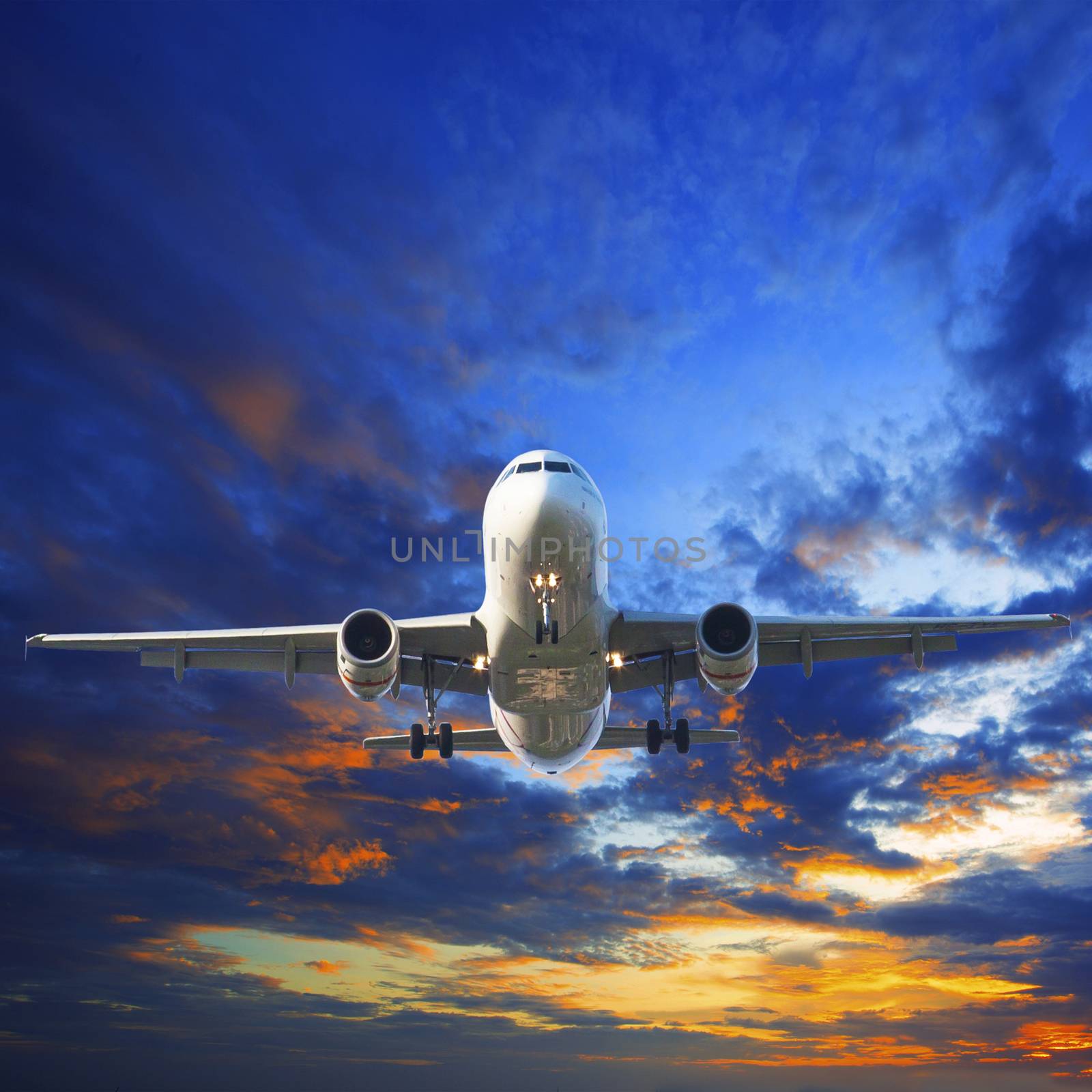 passenger jet plane preparing to landing against beautiful dusky by khunaspix
