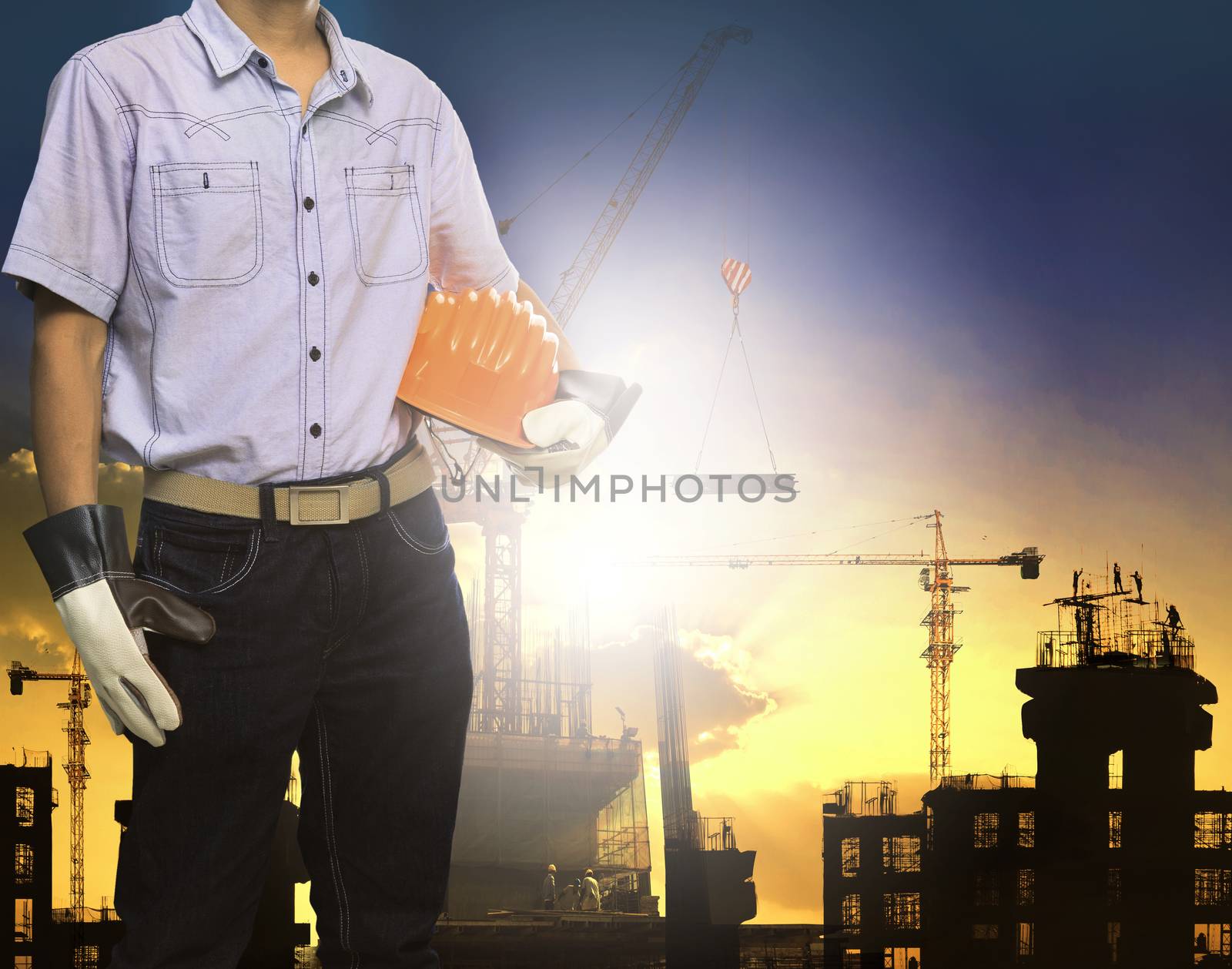 engineer man working with white safety helmet against crane and  by khunaspix