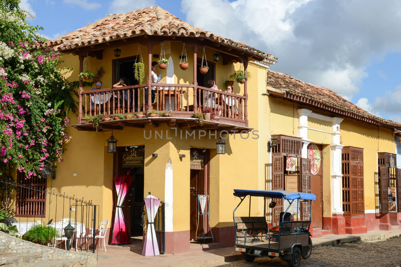 Trinidad, Cuba - 9 january 2016: people drinking and eating on the balcony of a restaurant in the colonial town of Trinidad in Cuba