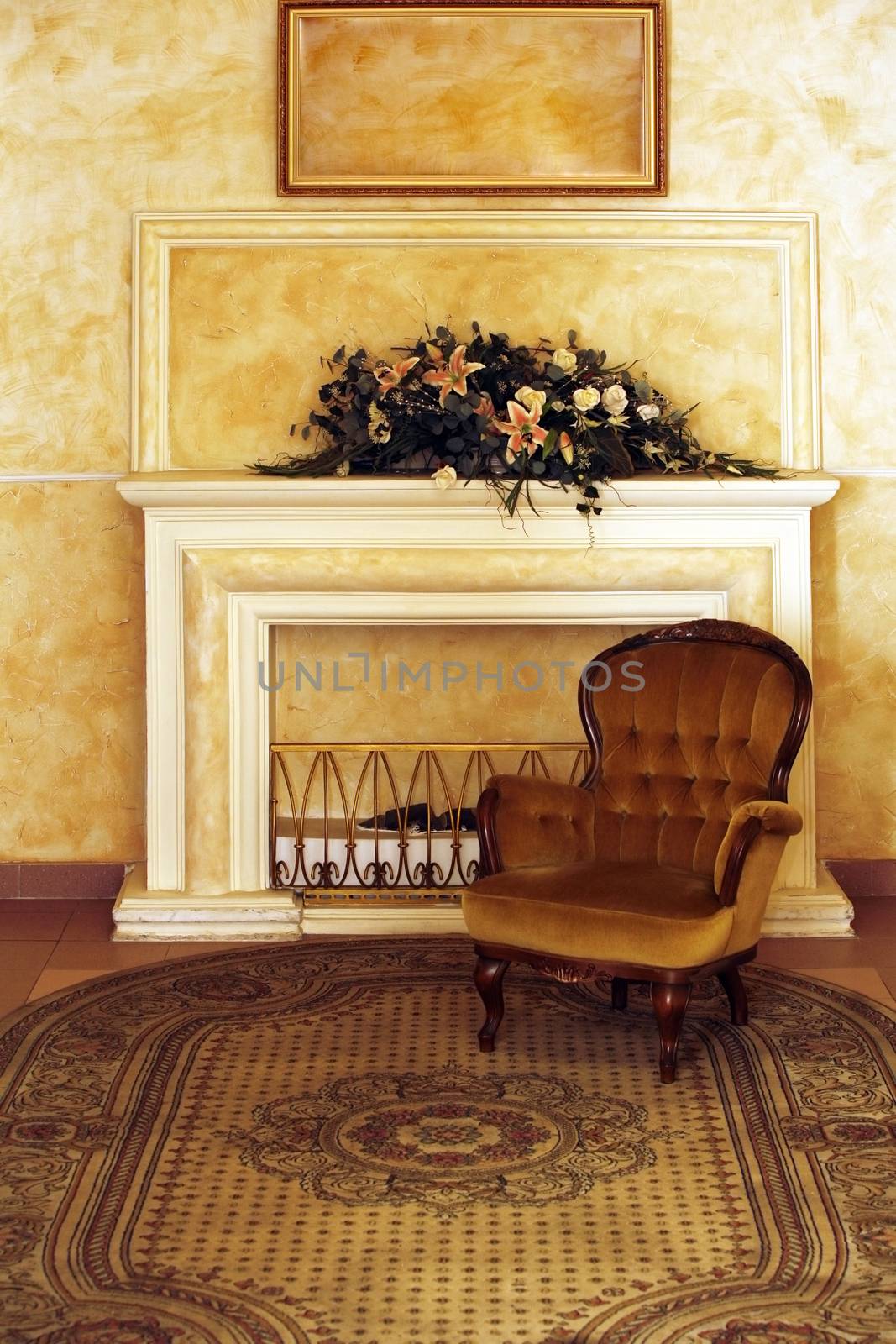 Velvet armchair on a background of a fireplace