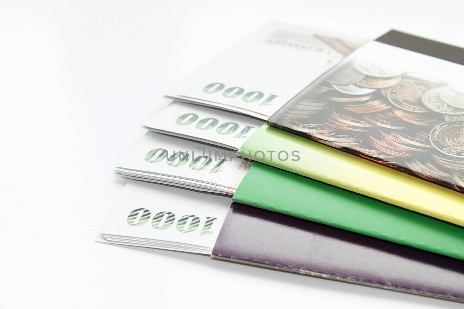 Concept of savings : Money and savings account passbook on white background