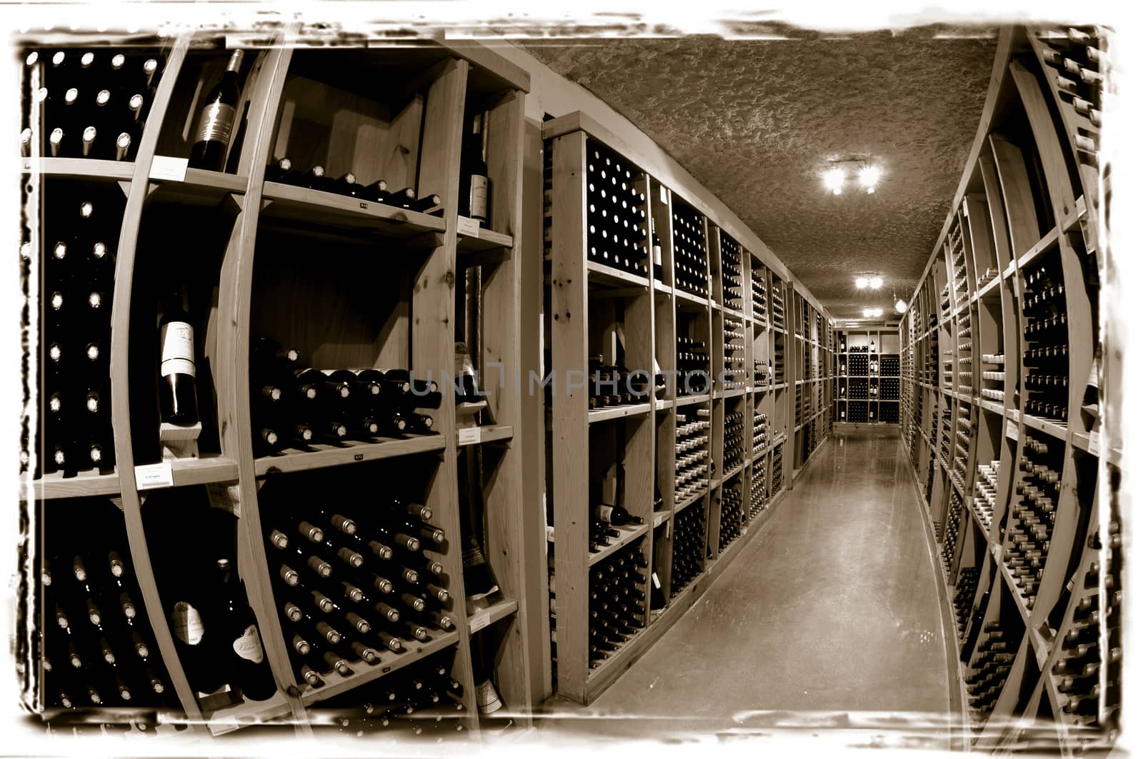 Wine bottles on wooden shelf in wine store, France