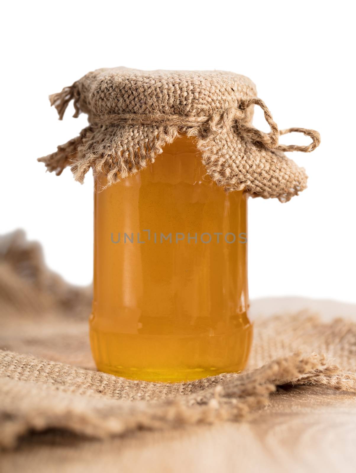  jar with honey close-up on white background
