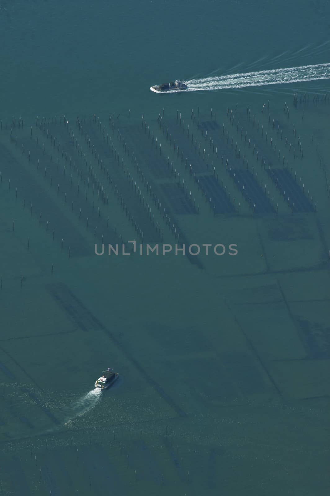 Aerial view of oyster boat returning to harbor , Arcachon, France