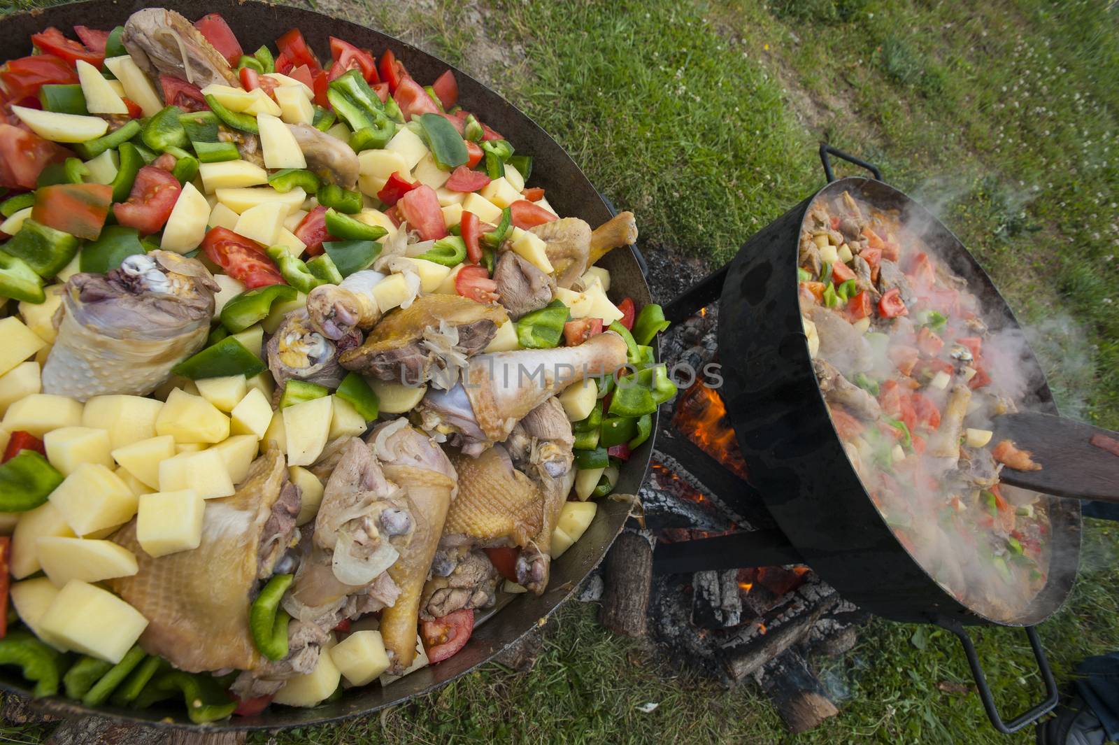 Cooking meal outdoors with pots on an open fire, France