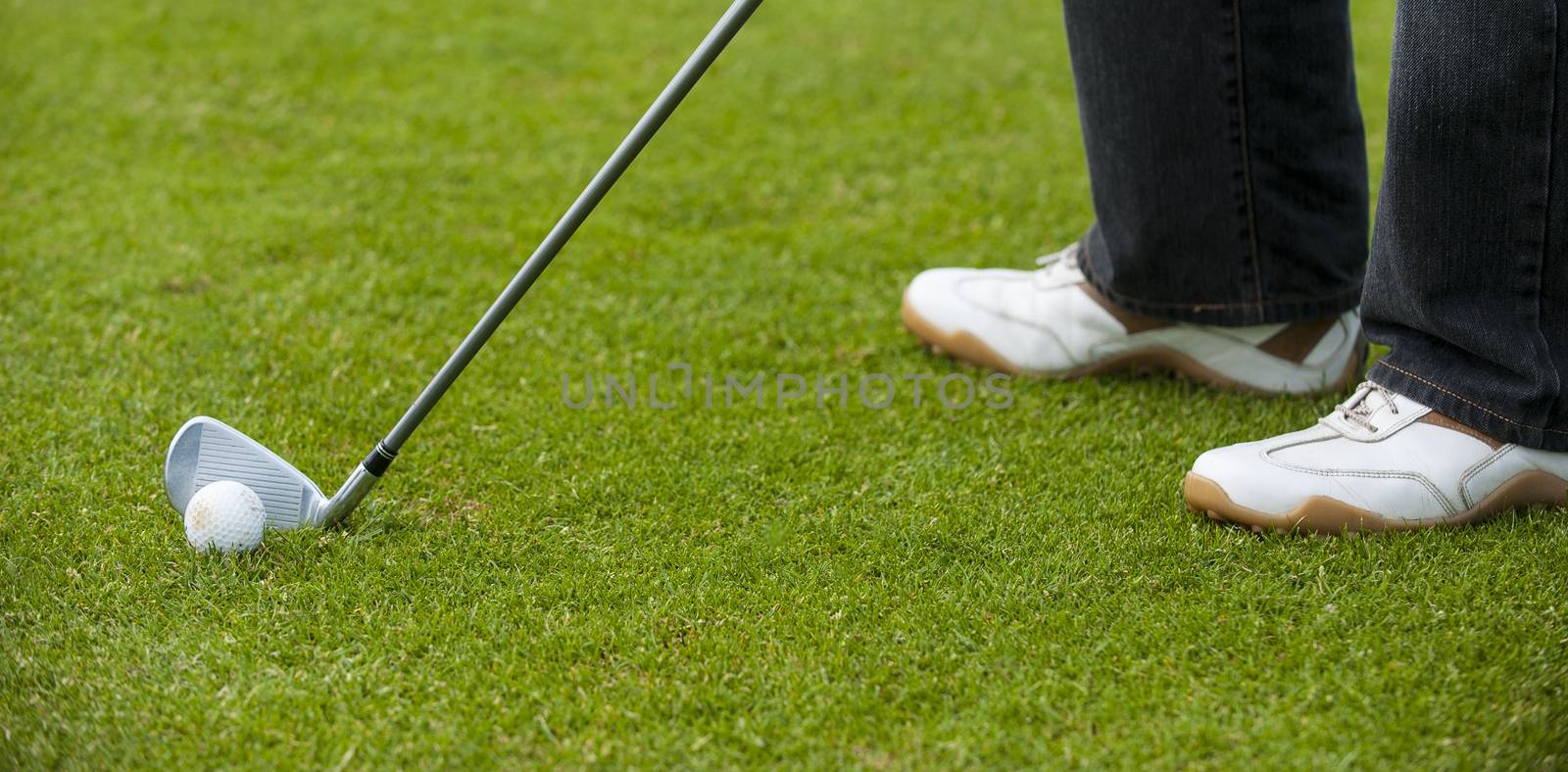 Golf club and ball in grass, France