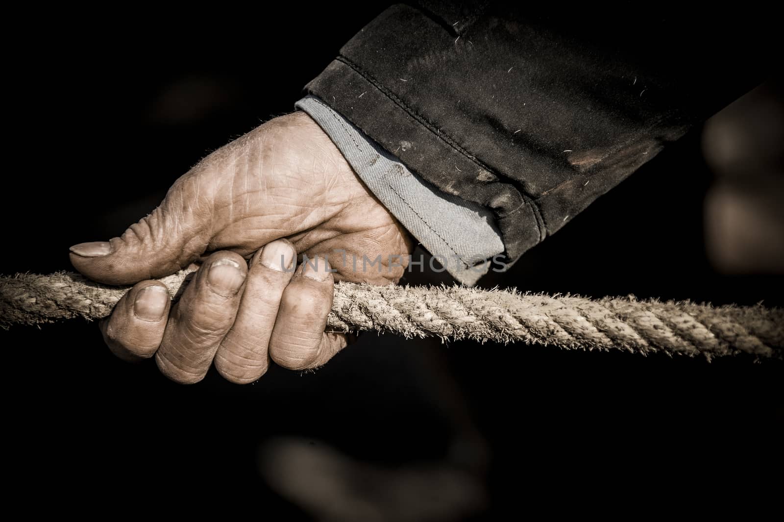 Hand pulling the rope, Grey background, France