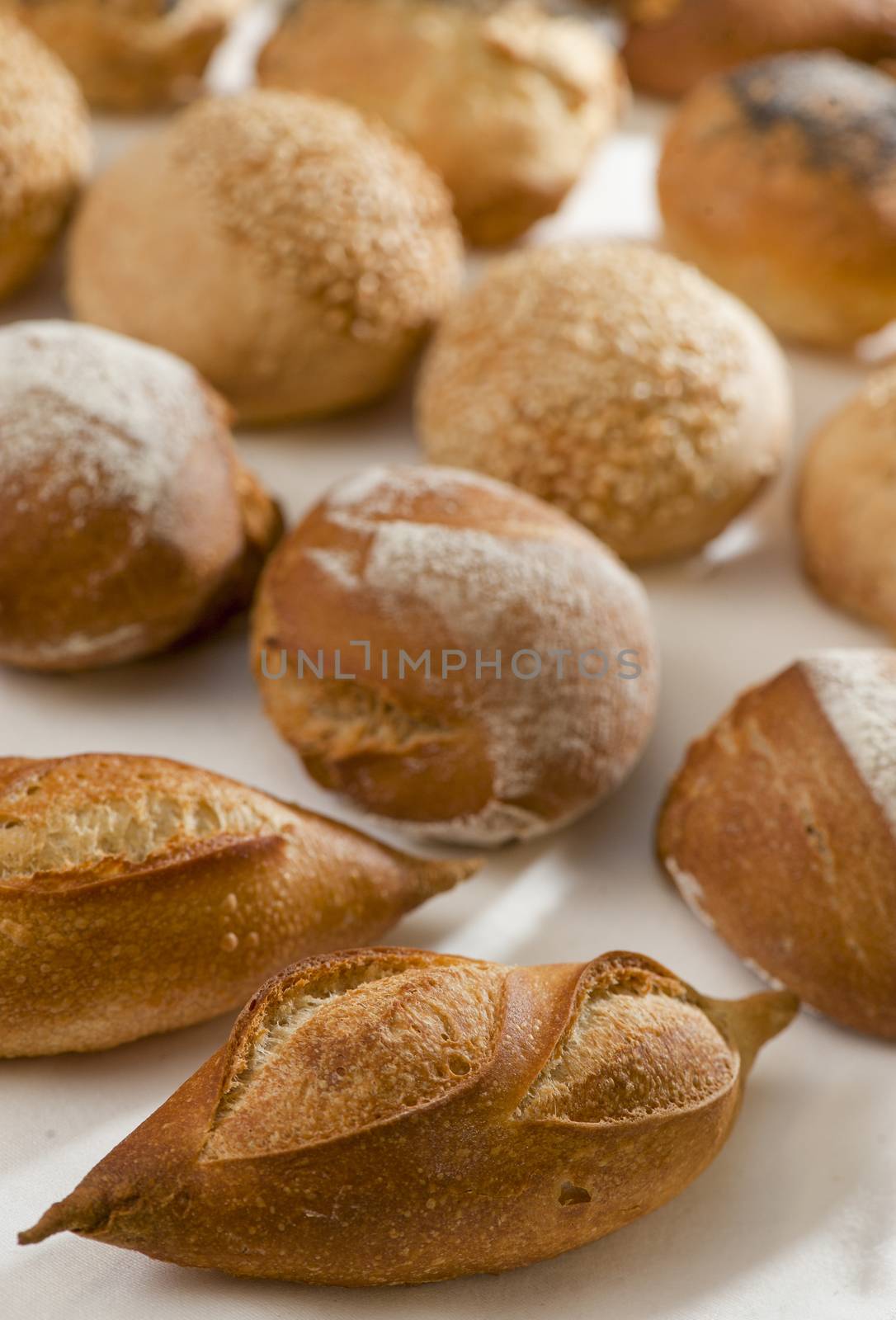Small French bread rolls on a table at the baker's, France