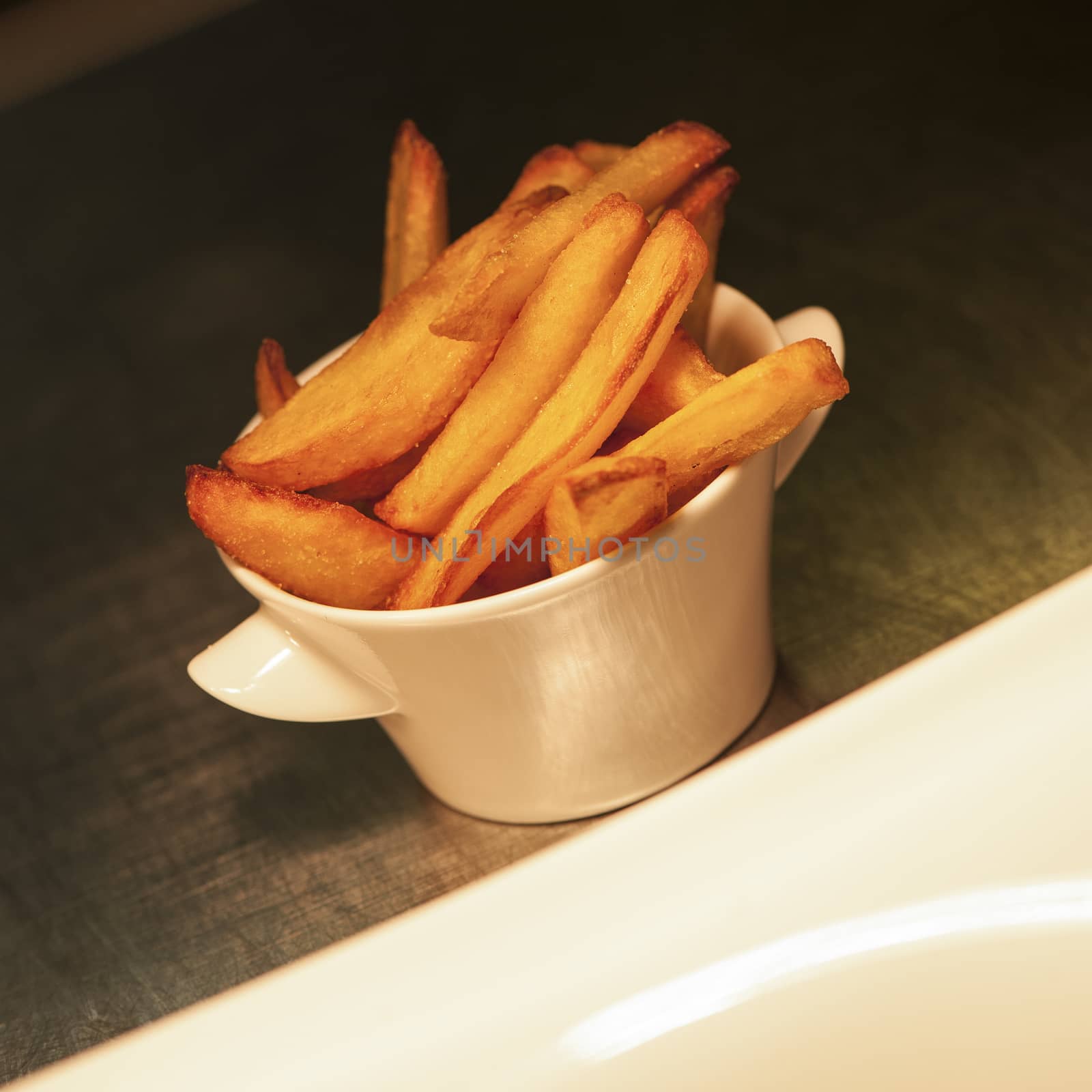 Serving French fries in a pot restaurant, France