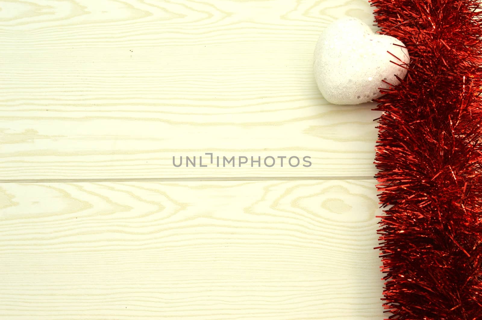Red garland with white hearts on wooden background