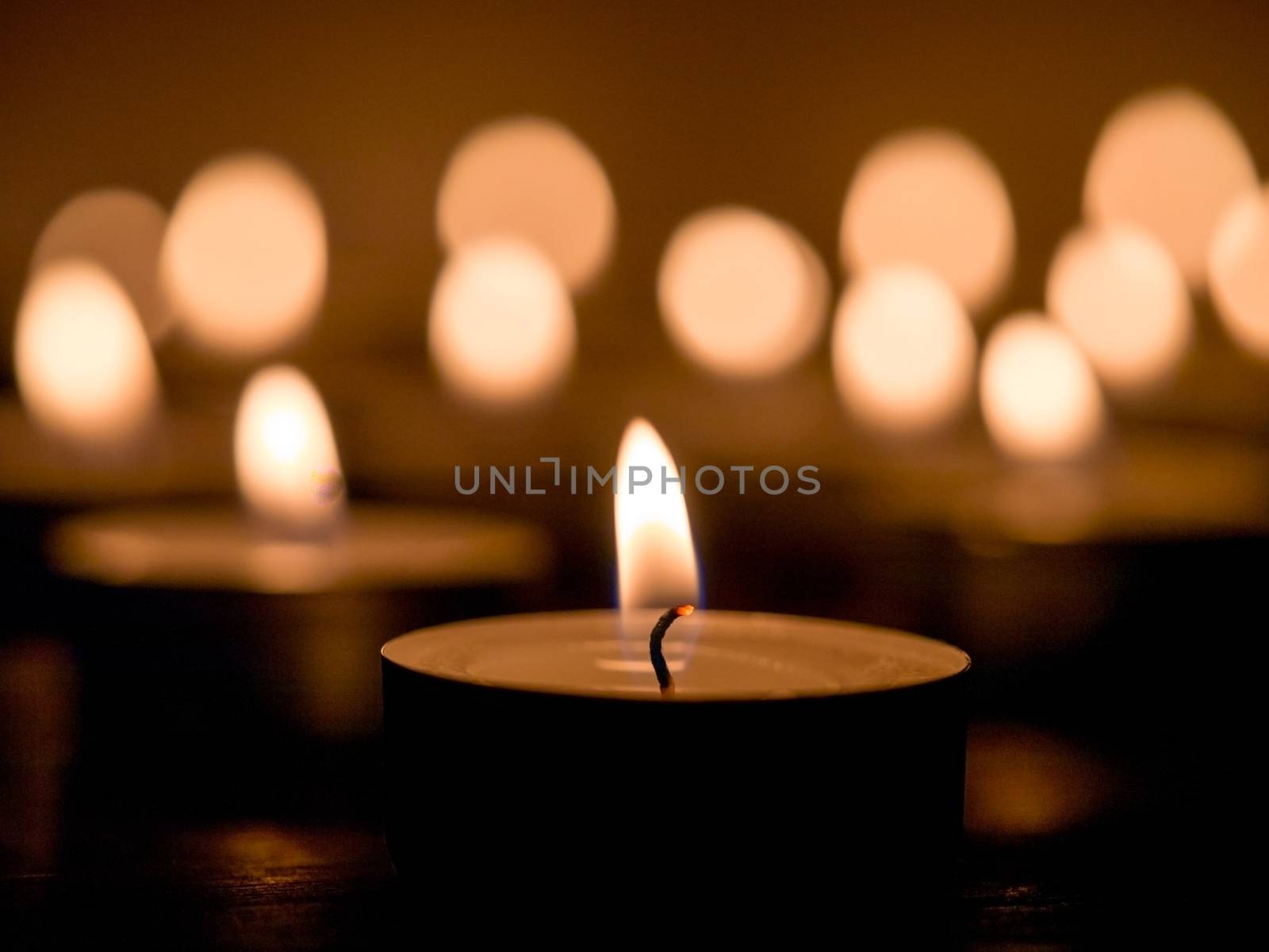candle light on dark background with bokhe. Shallow DOF. Copy space