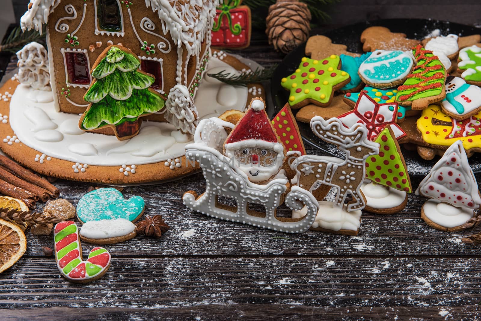 Homemade gingerbreads for new years and christmas on wooden background, xmas theme