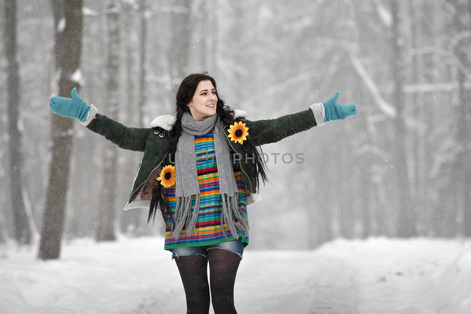 Beautiful young woman in a sweater on a winter walk in a park by weise_maxim