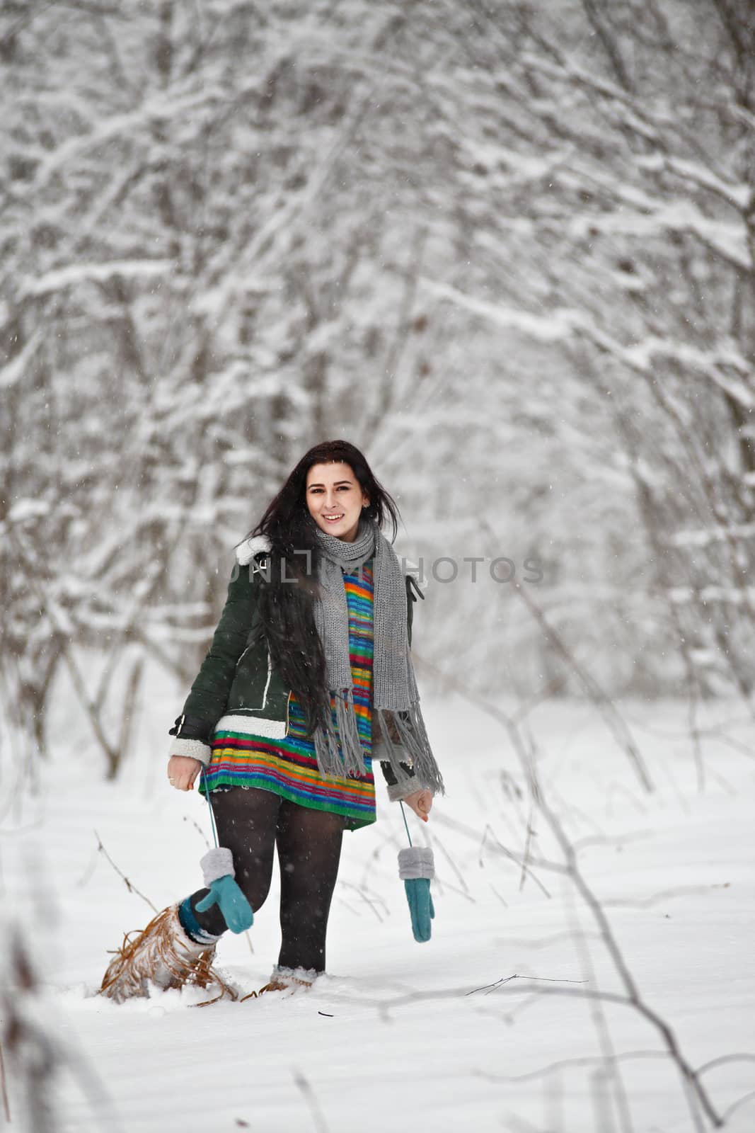 Beautiful young woman in a sweater on a winter walk in a wood by weise_maxim
